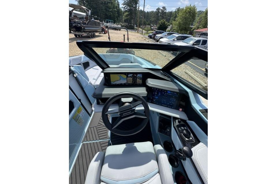 Interior view of 2026 MasterCraft XStar 25 boat cockpit with modern controls and displays.