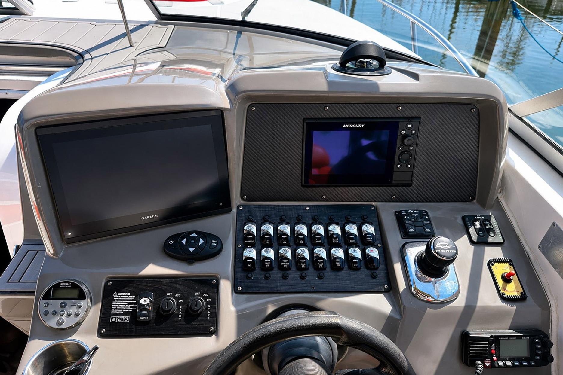 Control panel of 2012 Rinker 310 Express Cruiser LE with Garmin and Mercury displays.