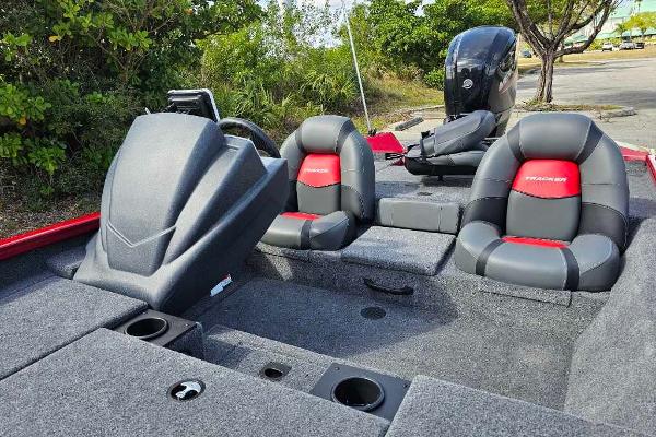 2025 Tracker Pro Team 175 boat interior with seating and console, parked outdoors.