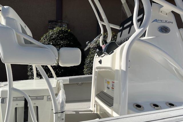 2026 Mako 24 APEX boat interior with white seating and control console.