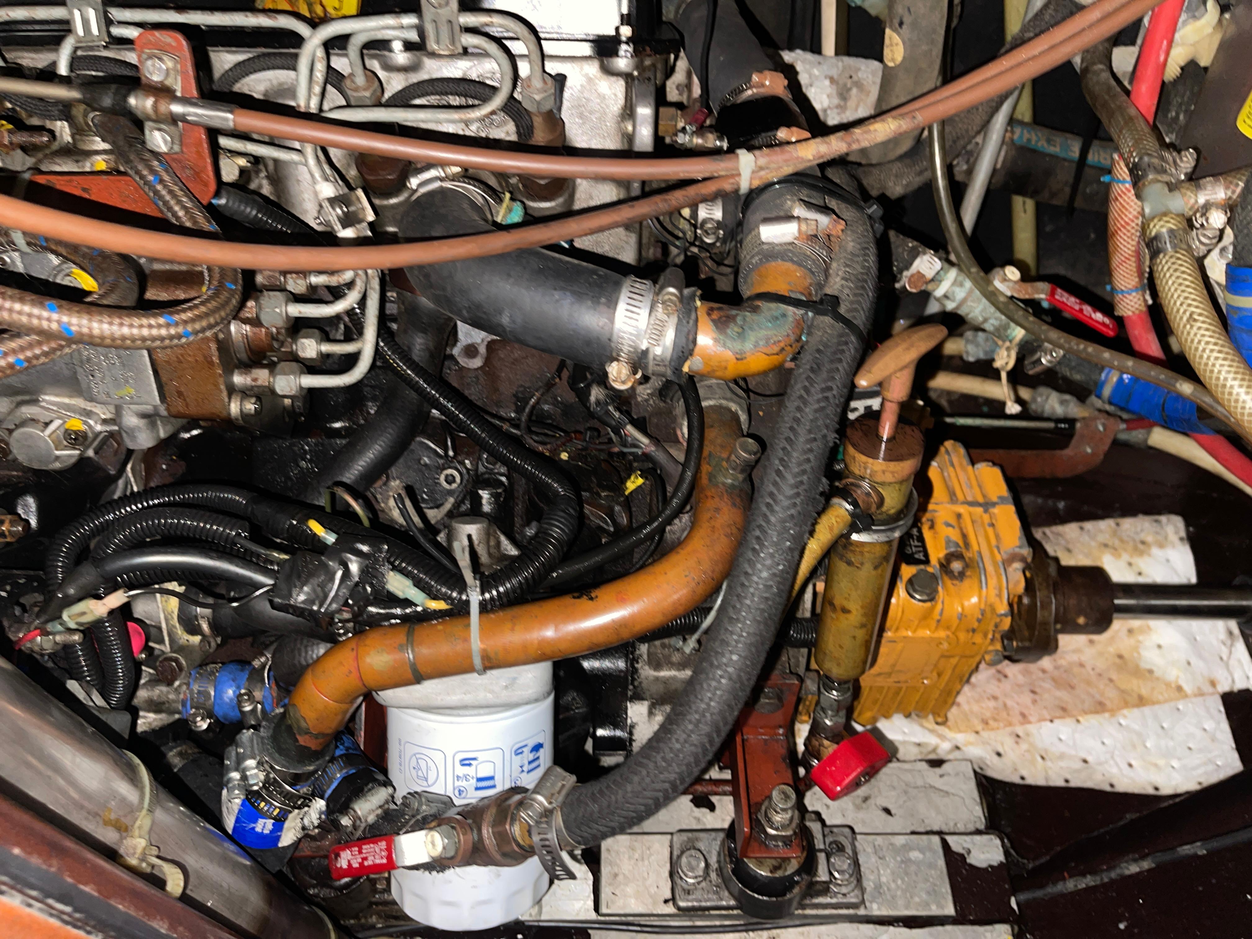 Engine compartment of a 1984 Hanseat 37, showcasing hoses and mechanical components.