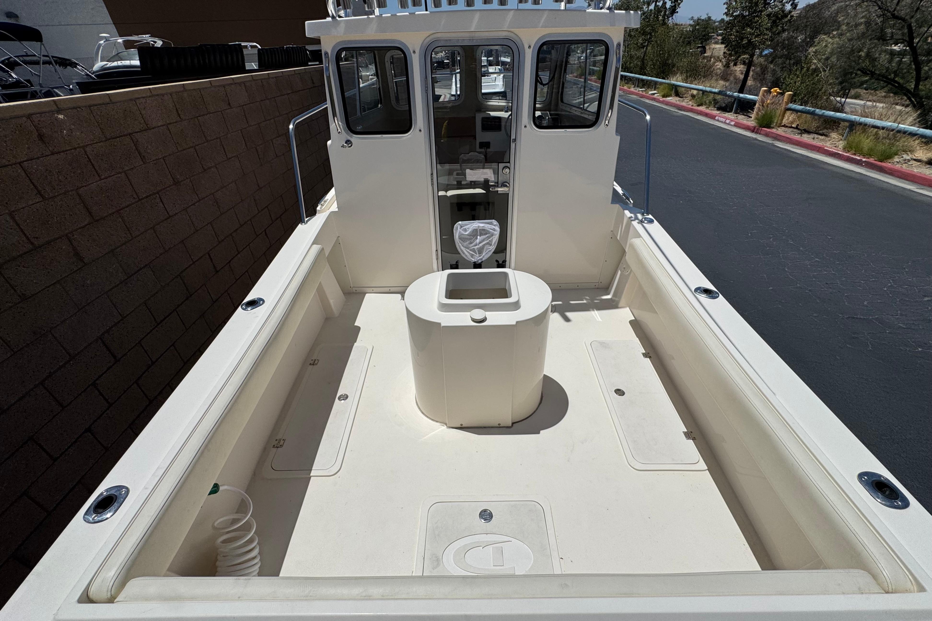 2017 Defiance Admiral 220 EX boat deck with spacious seating and storage compartments.
