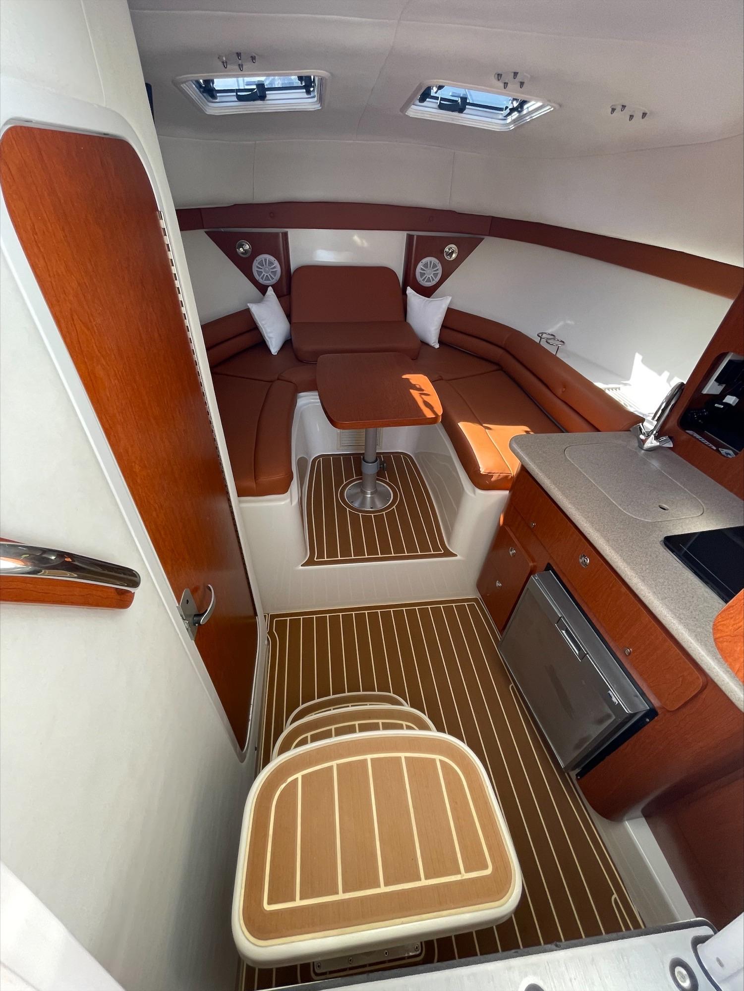 Interior of a Pro-Line 32 Express with wood flooring and seating area.