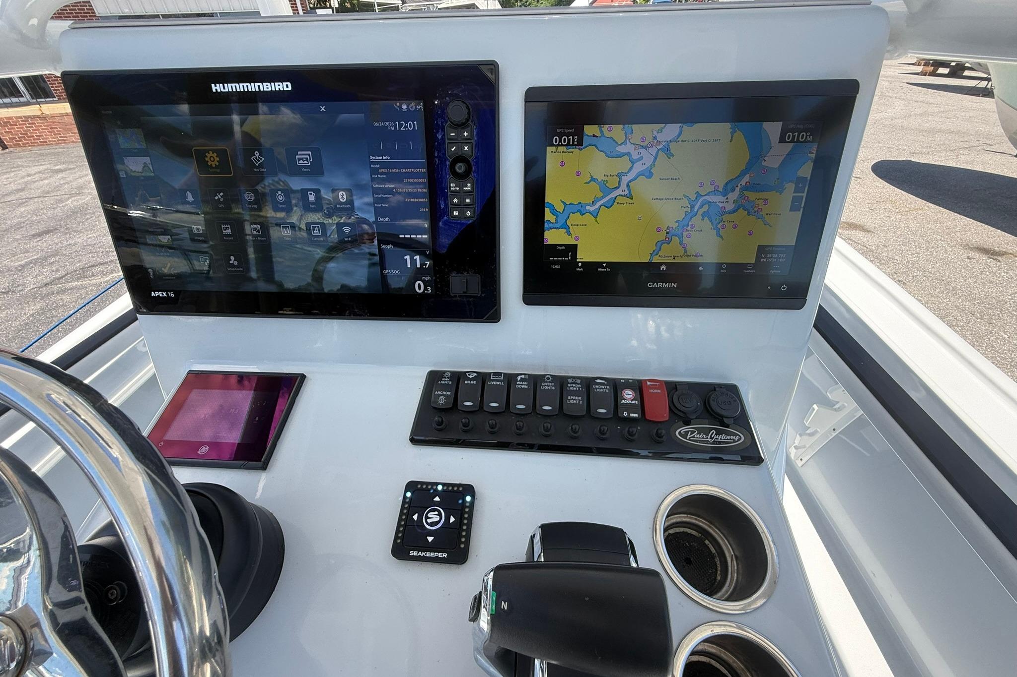 2024 Pair Customs 24 Center Console MV dashboard with Humminbird and Garmin displays.
