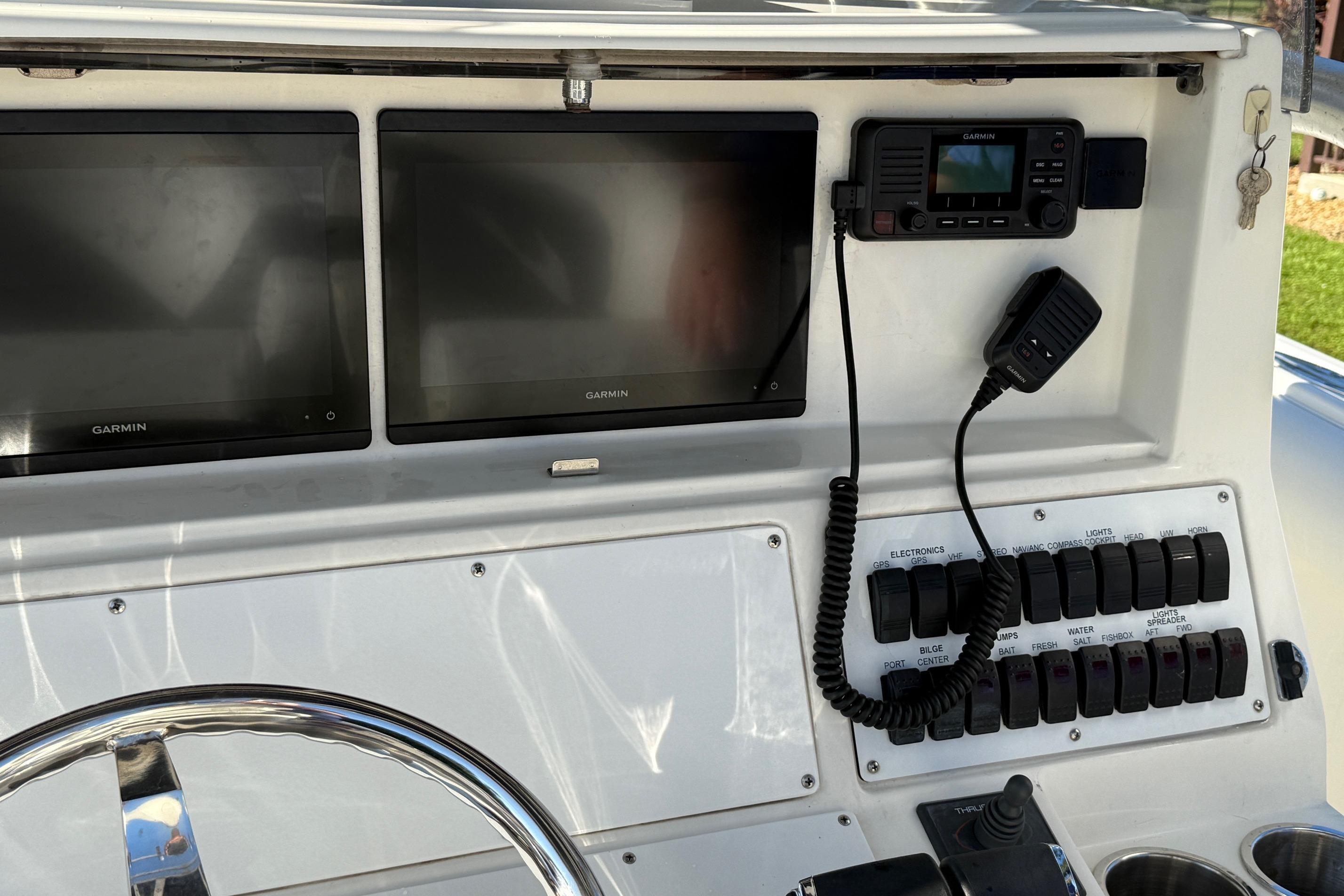 Control panel of a 2001 Marlago 35 Cuddy boat with Garmin displays.