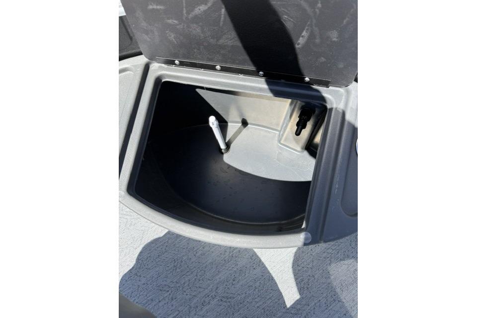 Open storage compartment on 2026 Sun Tracker Fishin' Barge 20 DLX boat.
