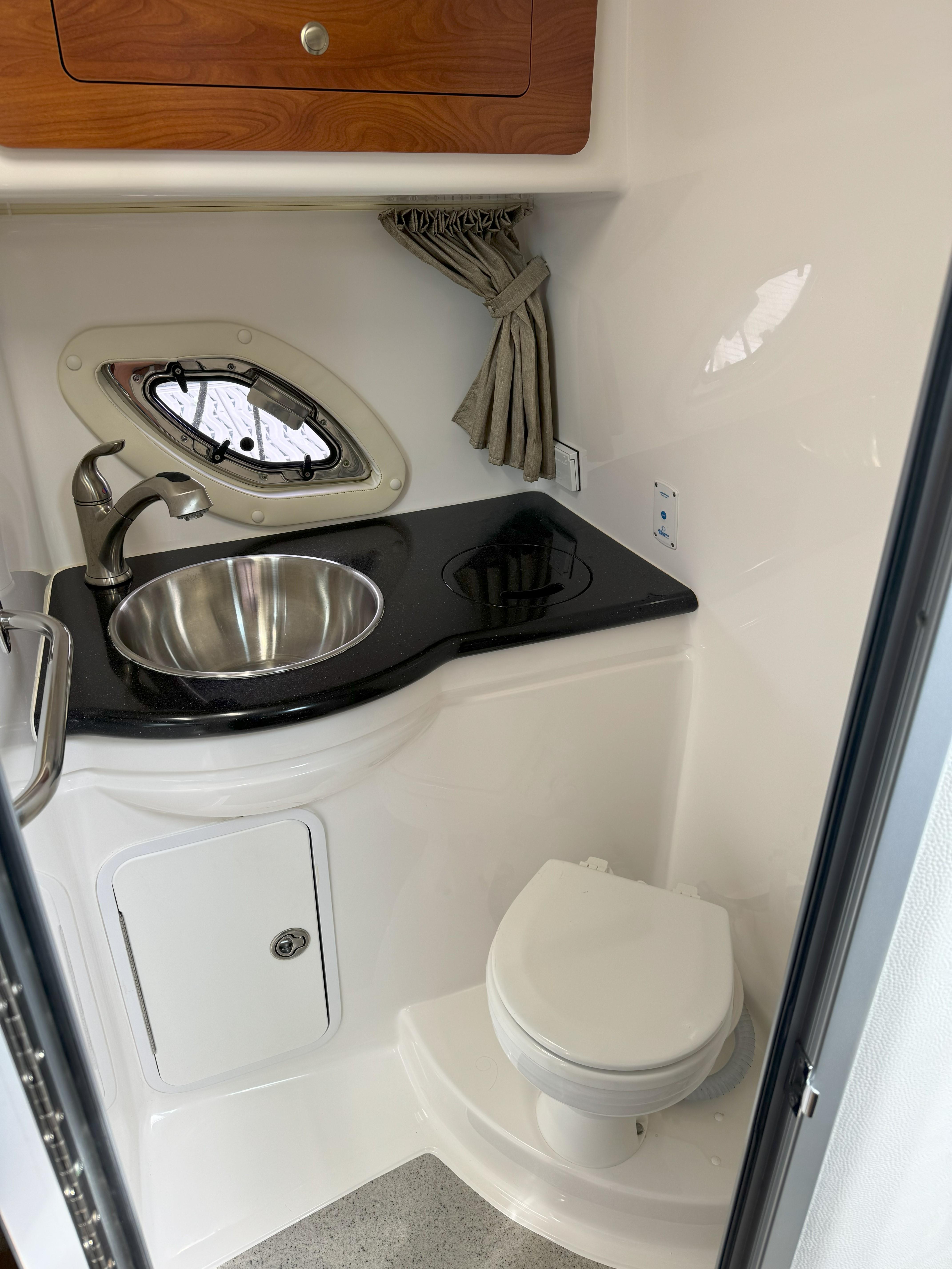 Interior of 2010 Rinker 310 Express Cruiser with sink and toilet.