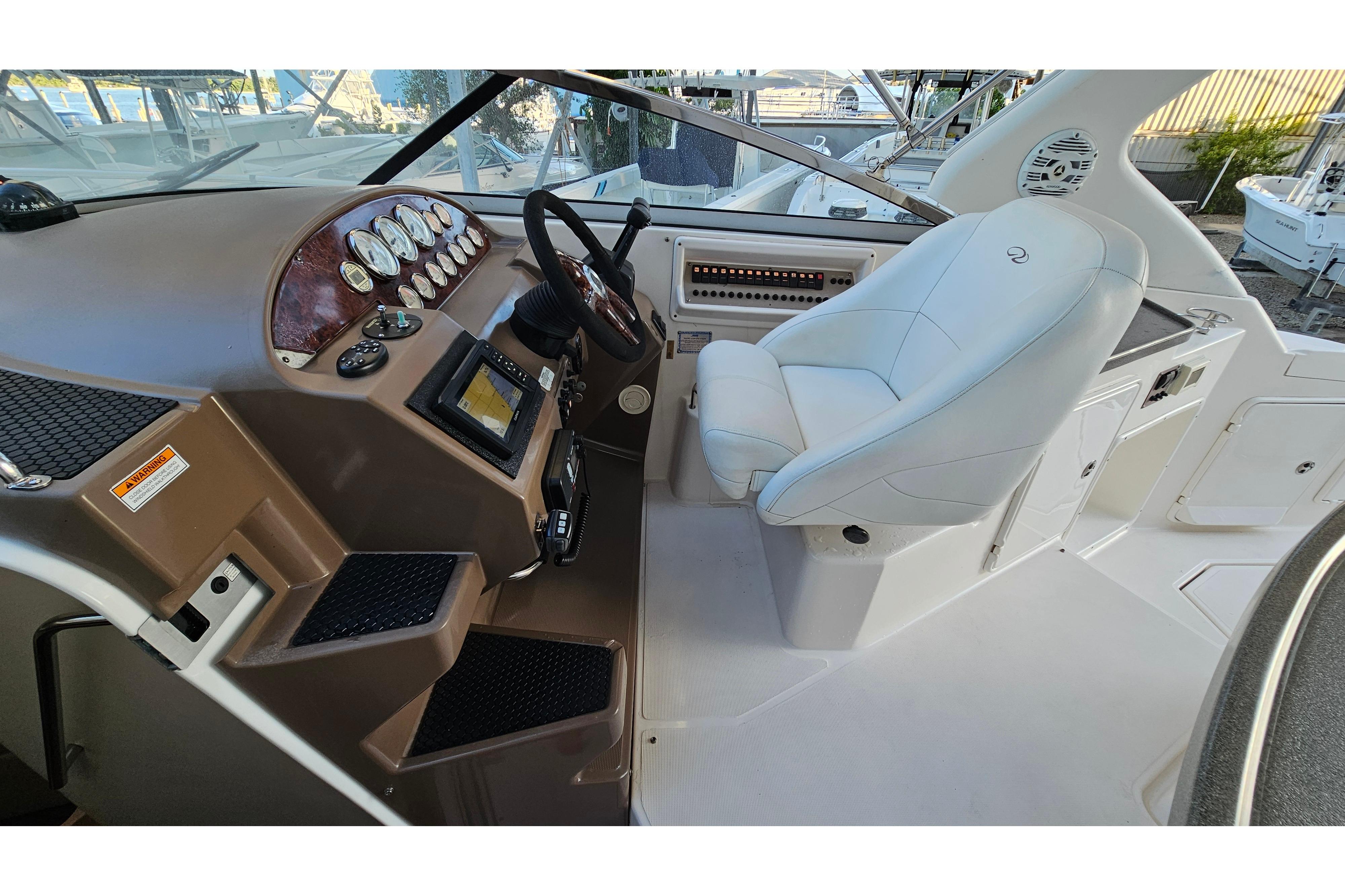 2005 Regal 3060 Window Express boat cockpit with steering wheel and control panel.