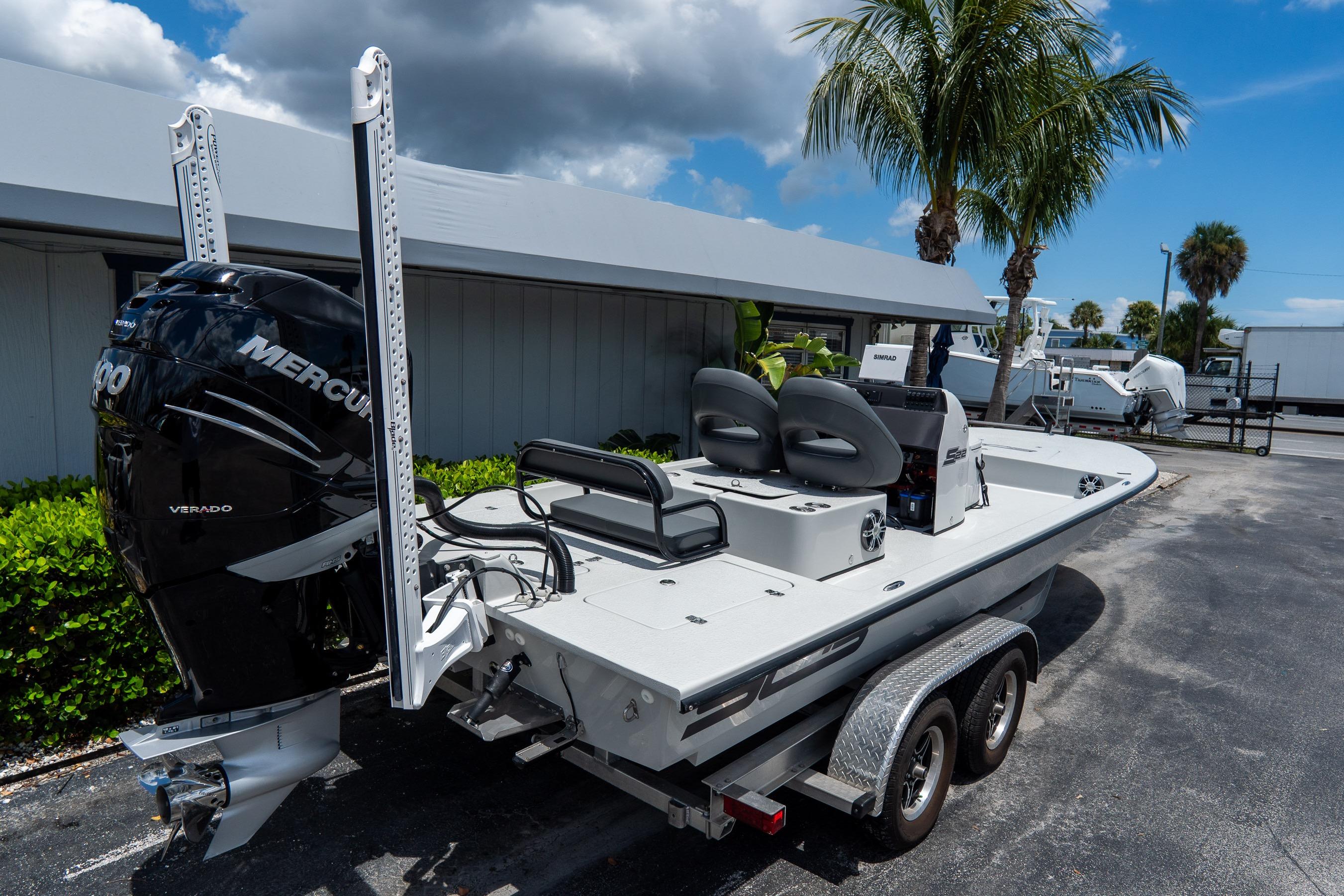 2021 SCB S22 boat with Mercury Verado engine on trailer, parked outdoors.