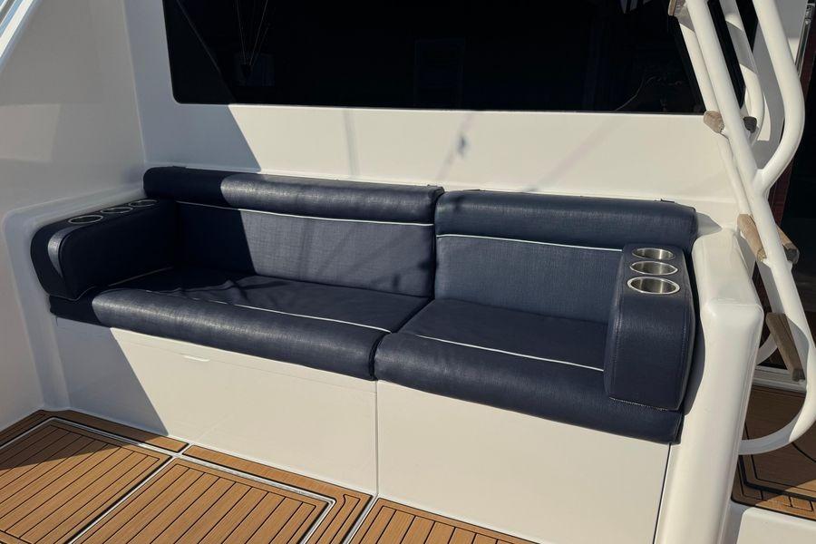 2002 Viking 61 Enclosed Bridge yacht seating with cup holders on teak deck.