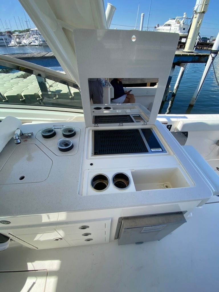 Cobia 330 boat kitchen with grill and sink, 2023 model.