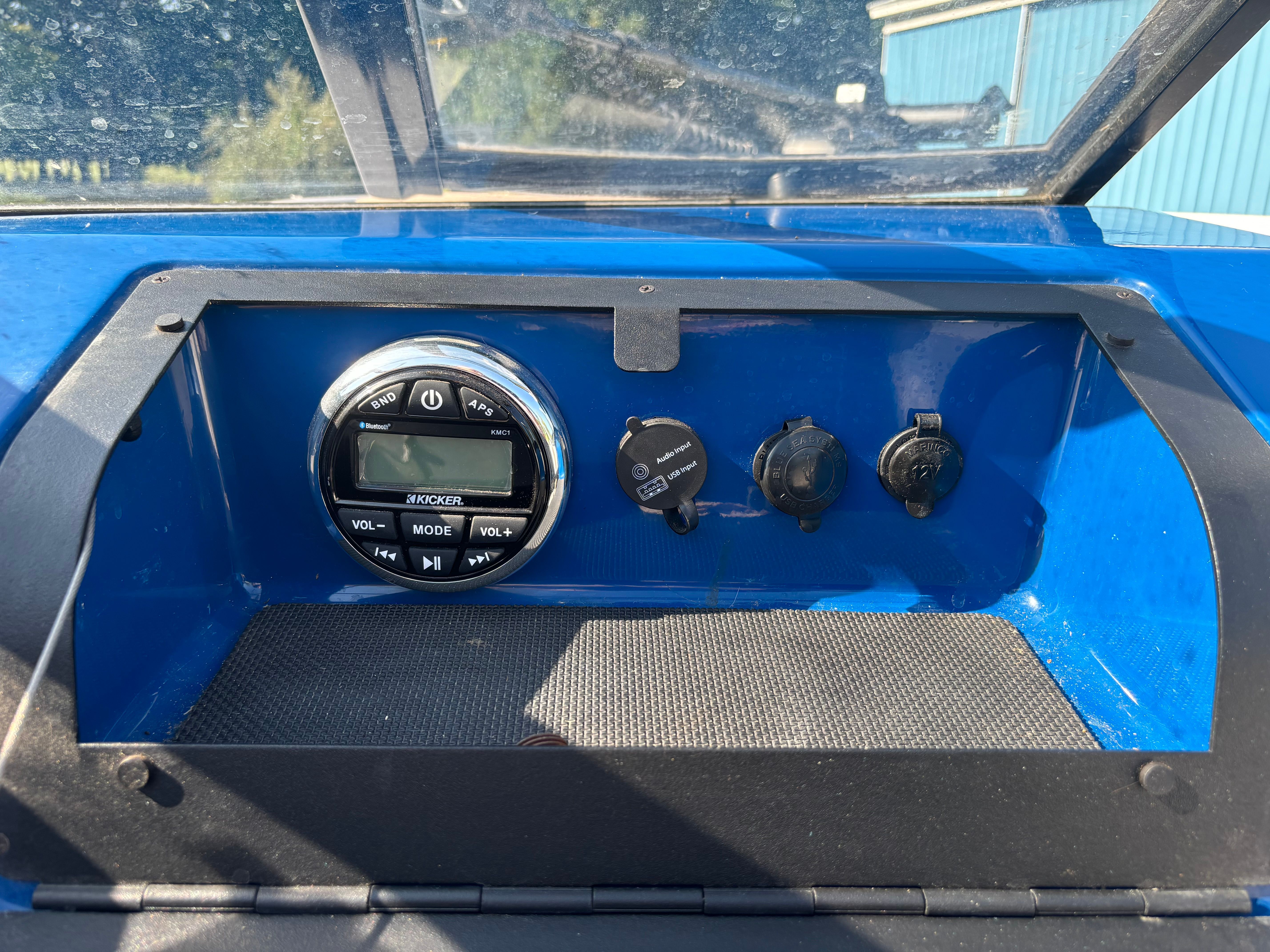 The dashboard of a Glastron GTSF 185 boat with controls and ports.