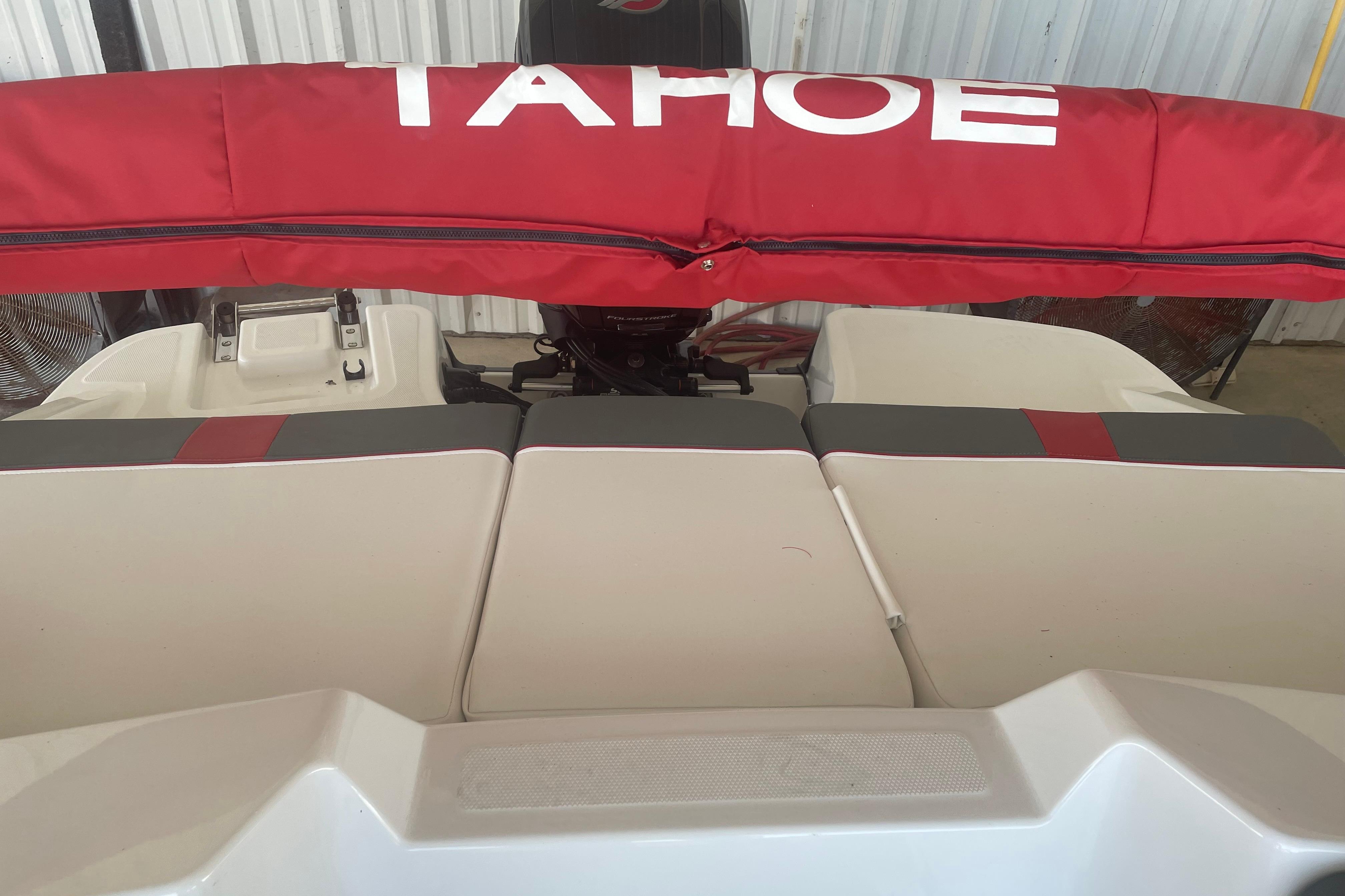 2026 Tahoe T18 boat with red cover and cushioned seating.