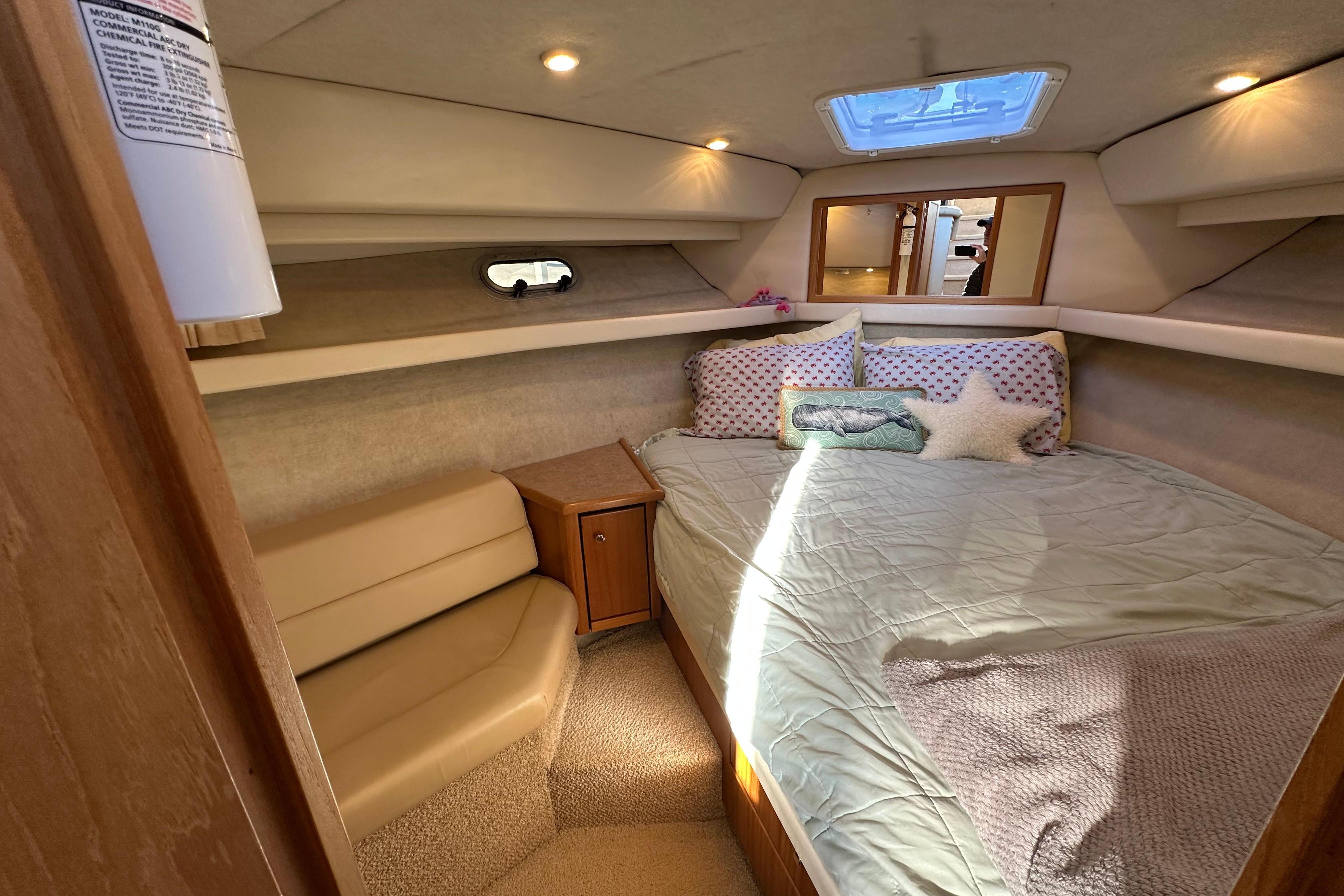 Cozy cabin interior of 2000 Bayliner 4087 Aft Cabin Motoryacht with bed and seating.
