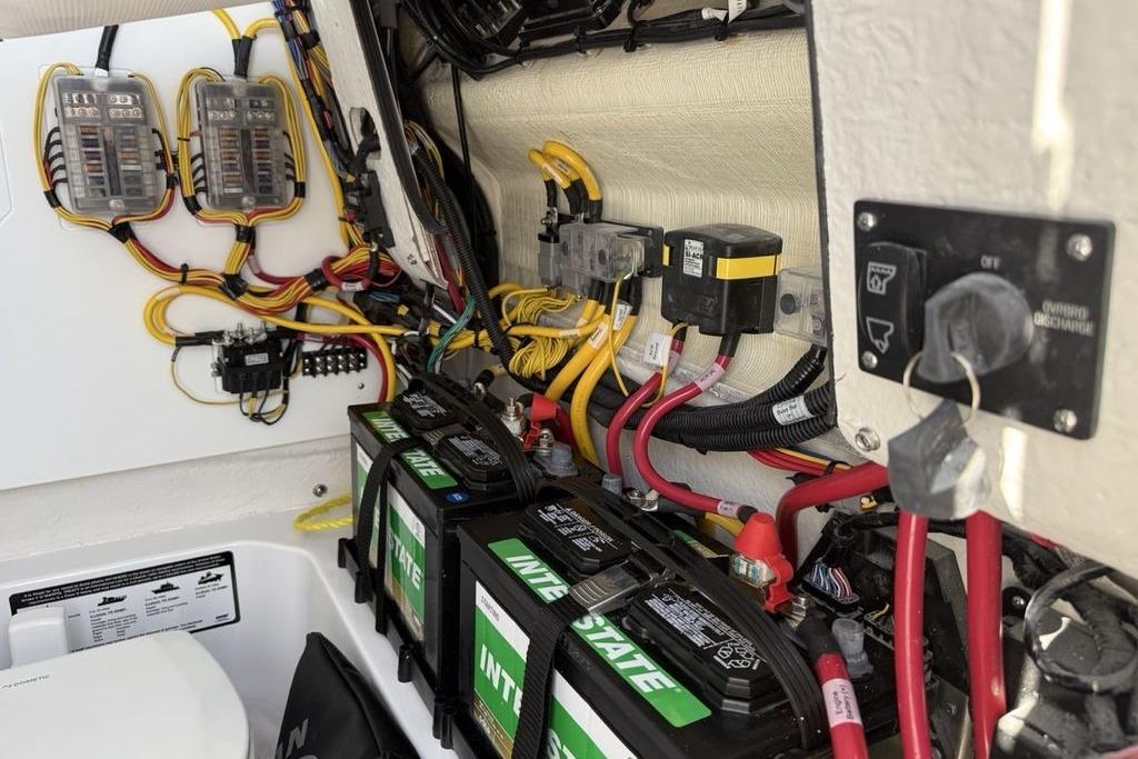 Electrical system of 2026 Sportsman Open 232 Center Console boat with batteries and wiring.
