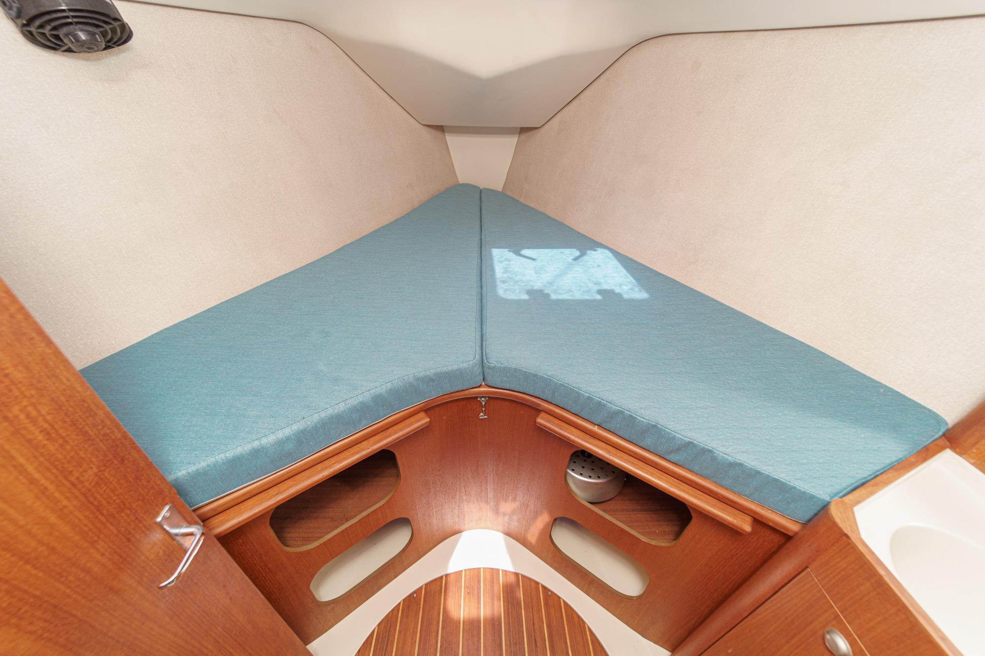 Interior cabin of a 1996 Hunter 376 sailboat with a V-berth and wooden accents.