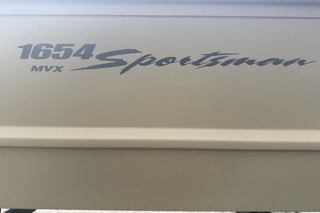 2026 Tracker Grizzly 1654 T Sportsman boat logo on a beige surface.