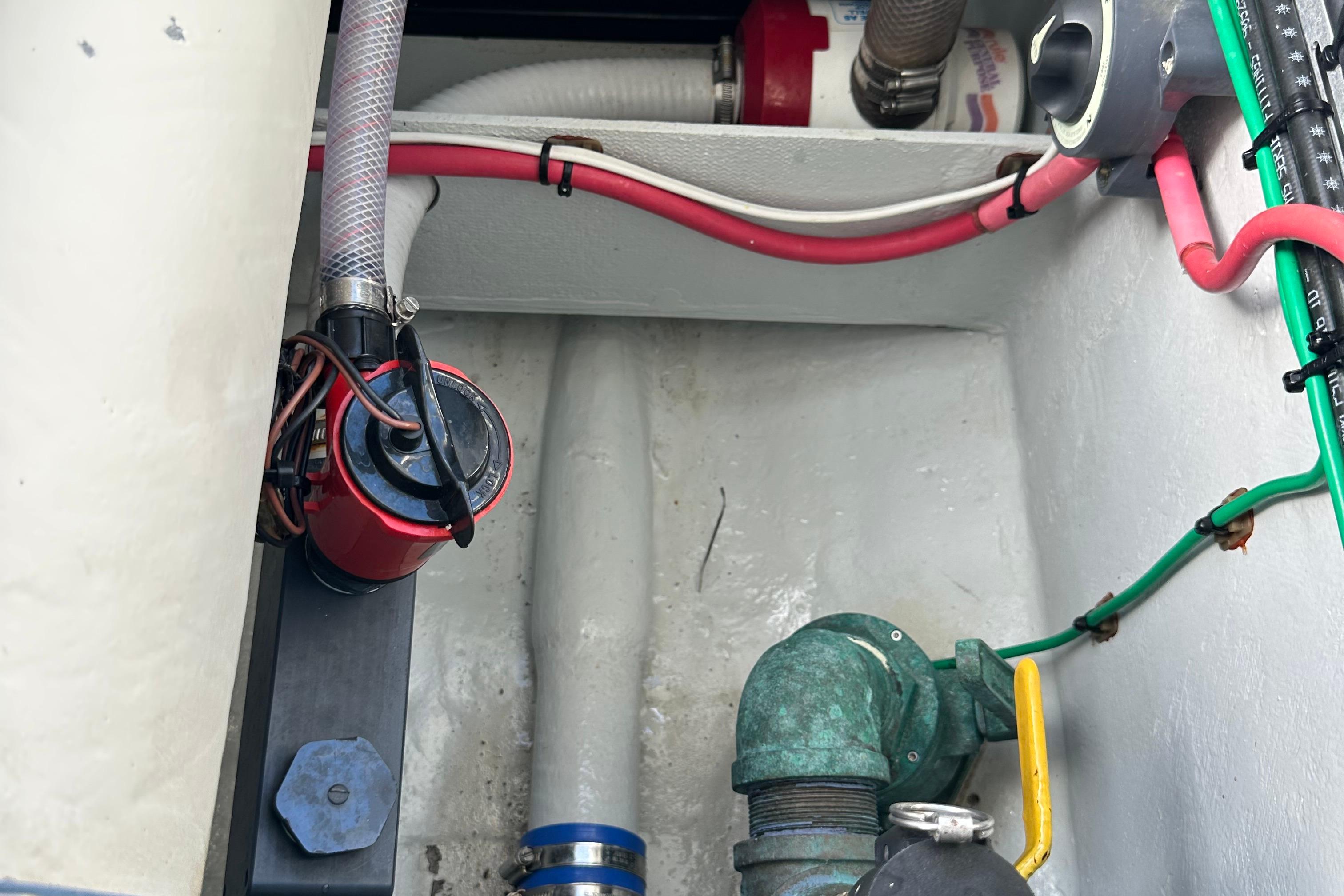 2004 SeaVee Center Console boat interior with visible wiring and plumbing components.