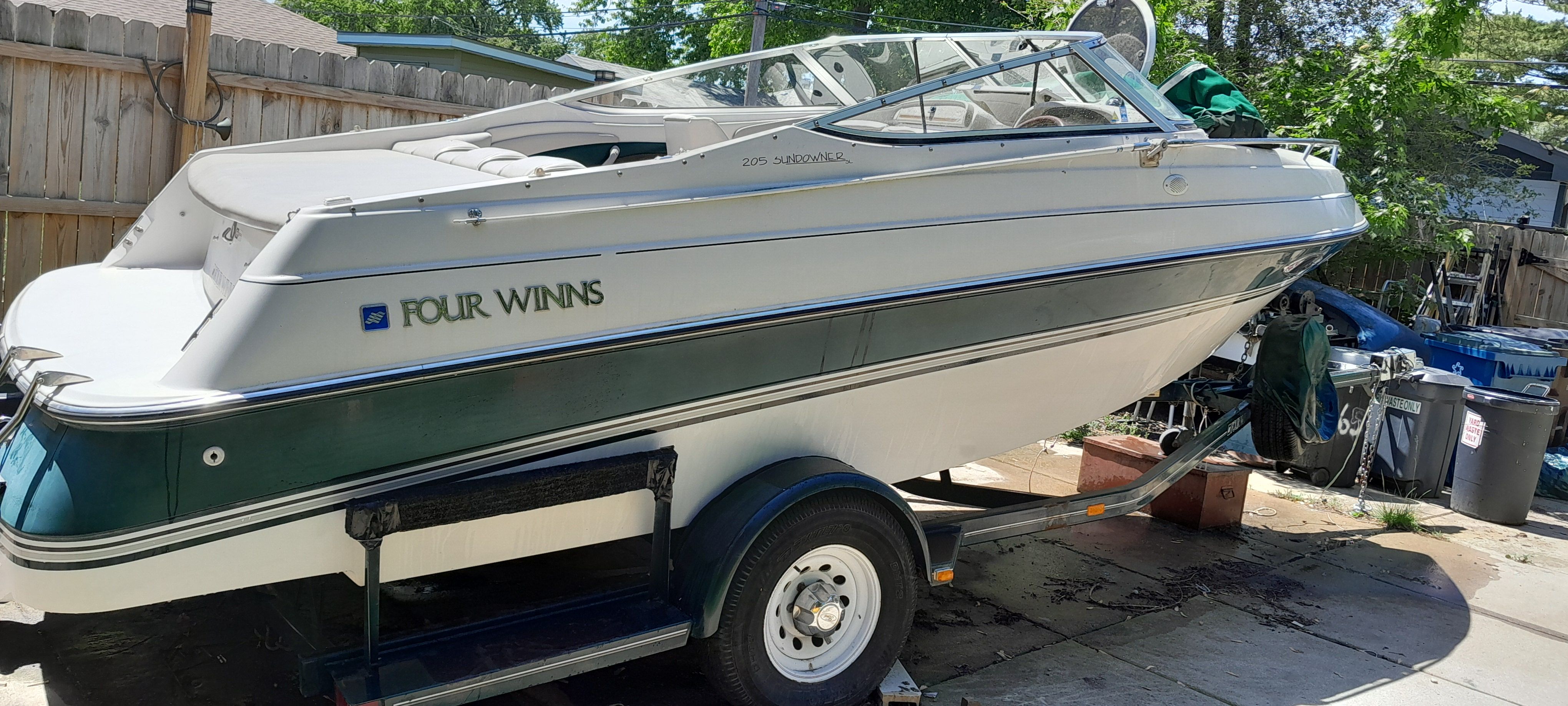 1995 Four Winns 205 Sundowner boat on trailer outdoors.