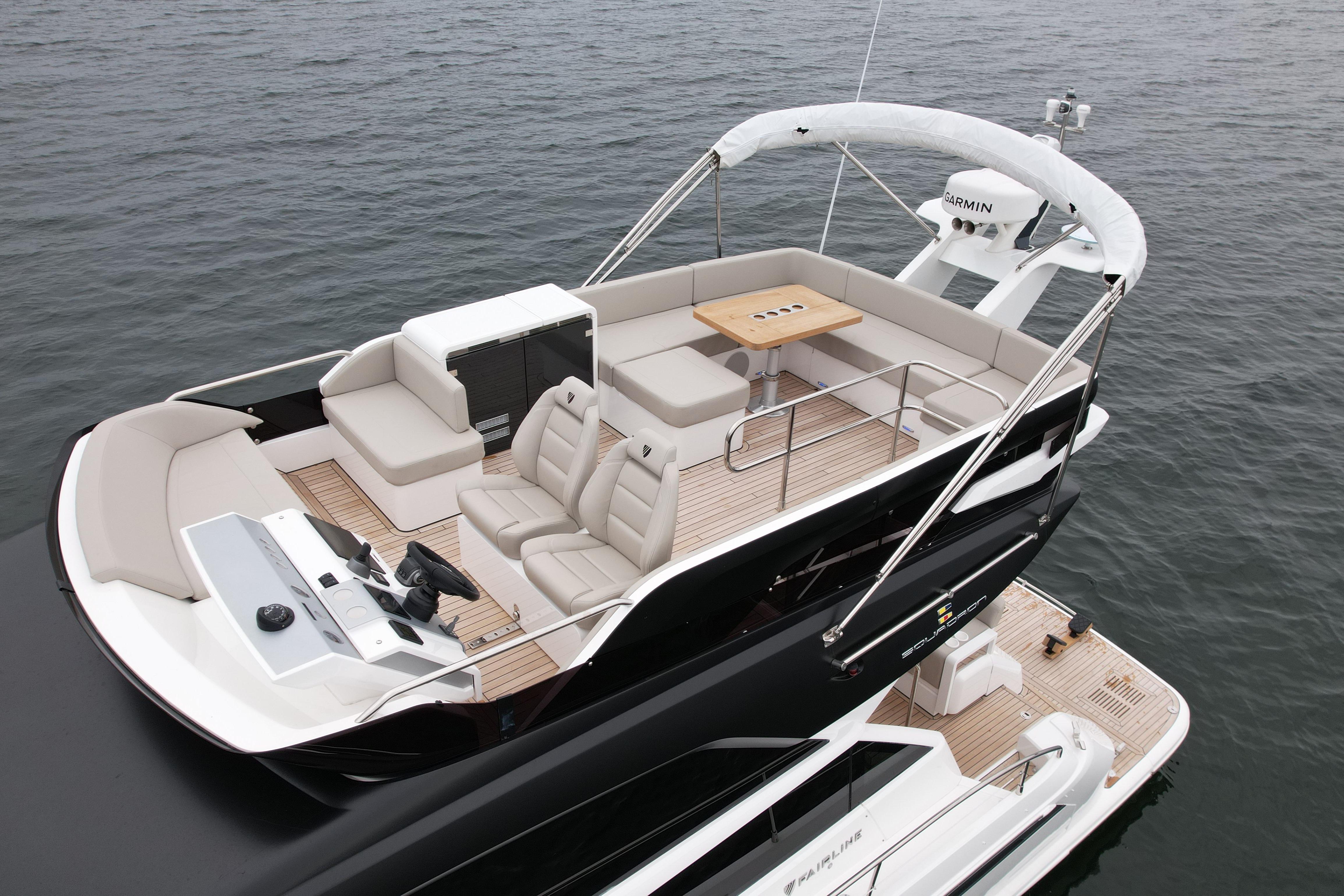 2024 Fairline Squadron 50 yacht with spacious deck and seating on open water.