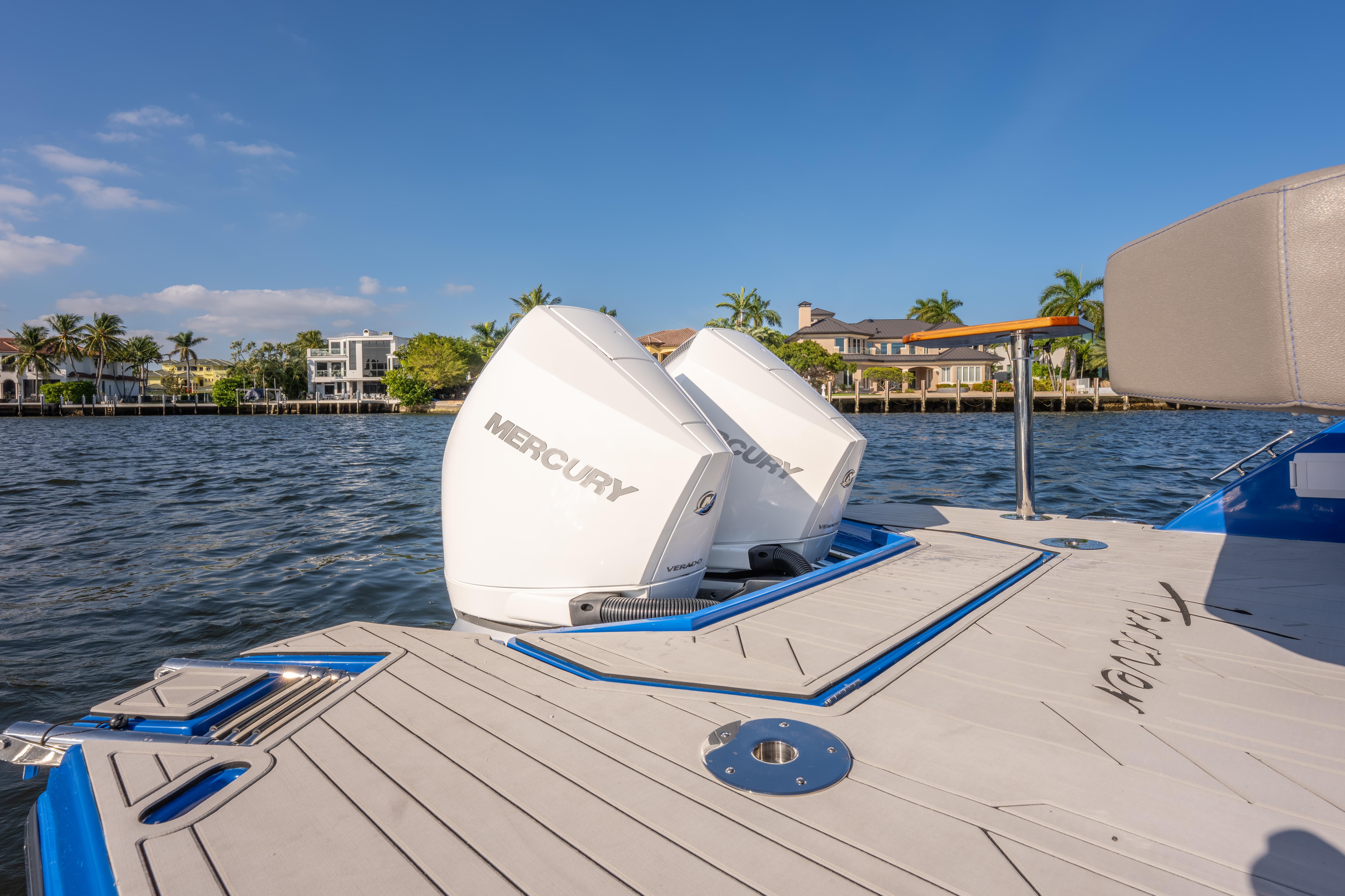 2026 Hanover 347 boat with dual Mercury outboard engines on a sunny waterfront.