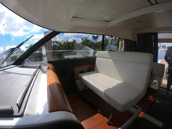 Interior of 2017 Jeanneau NC 11 boat with white seating and large windows.