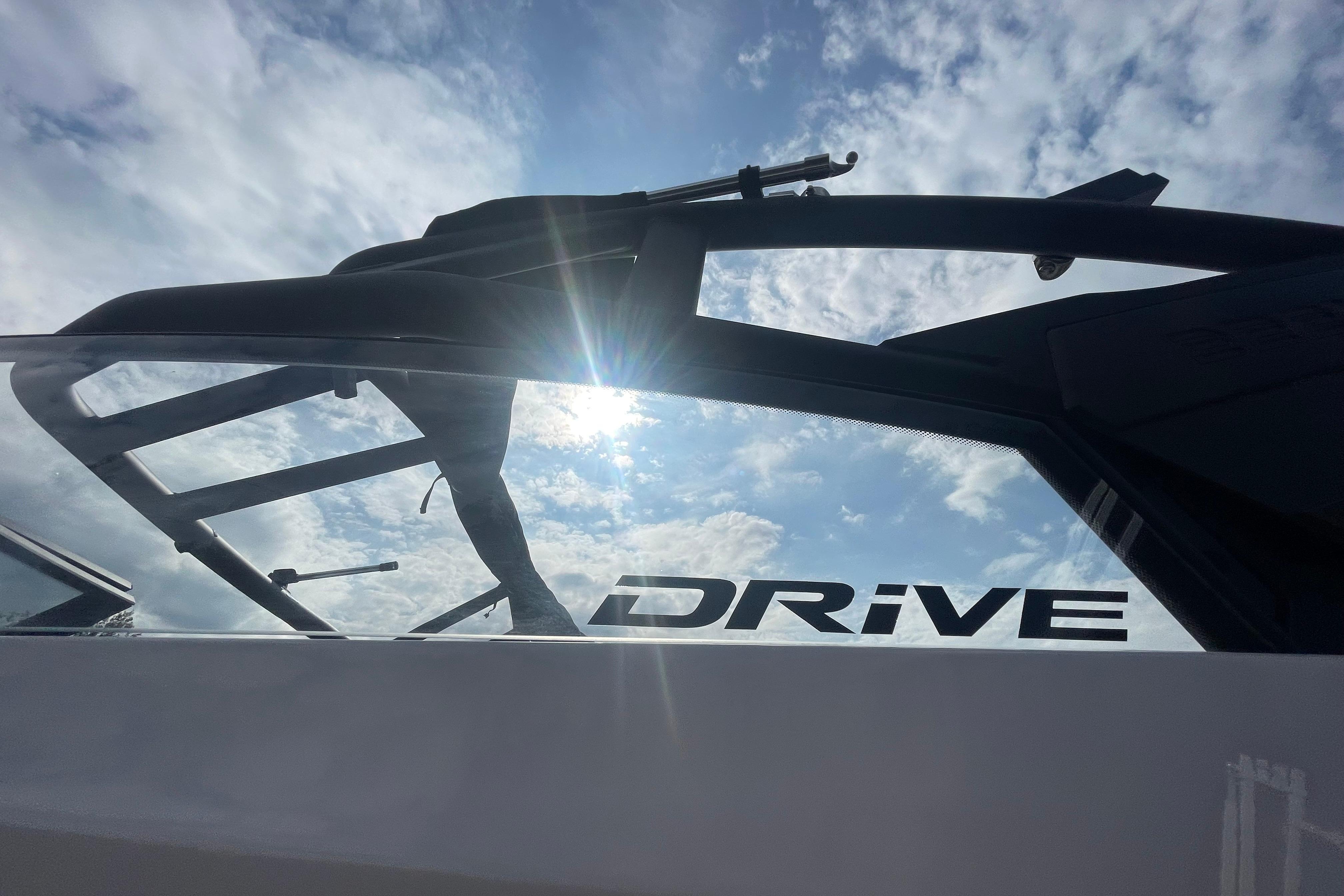 2026 Yamaha Boats 222XD with "Drive" logo, sunlit against a cloudy sky.