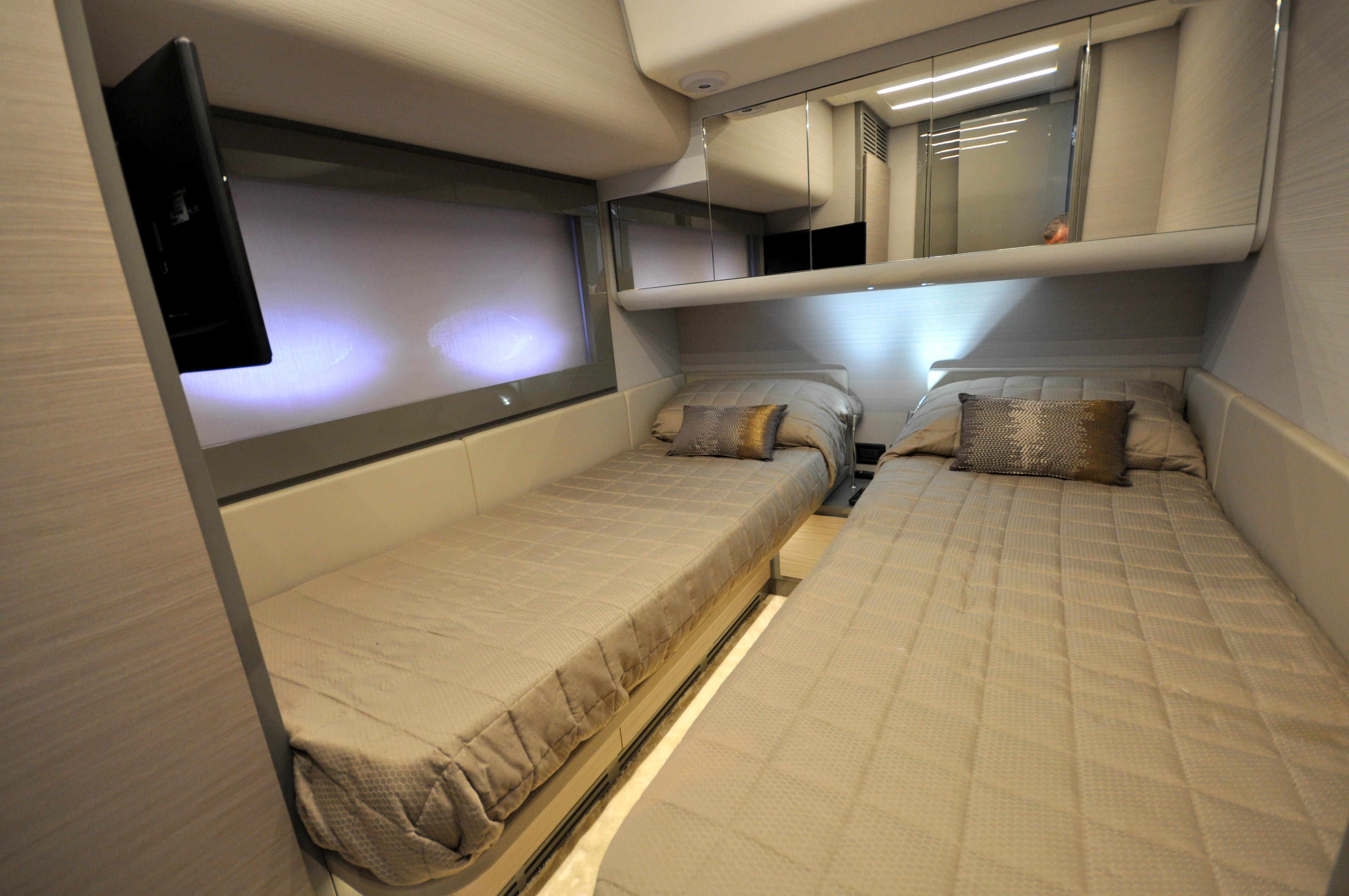 Luxurious twin bedroom in 2020 Pershing 62' yacht, featuring modern design and elegant decor.