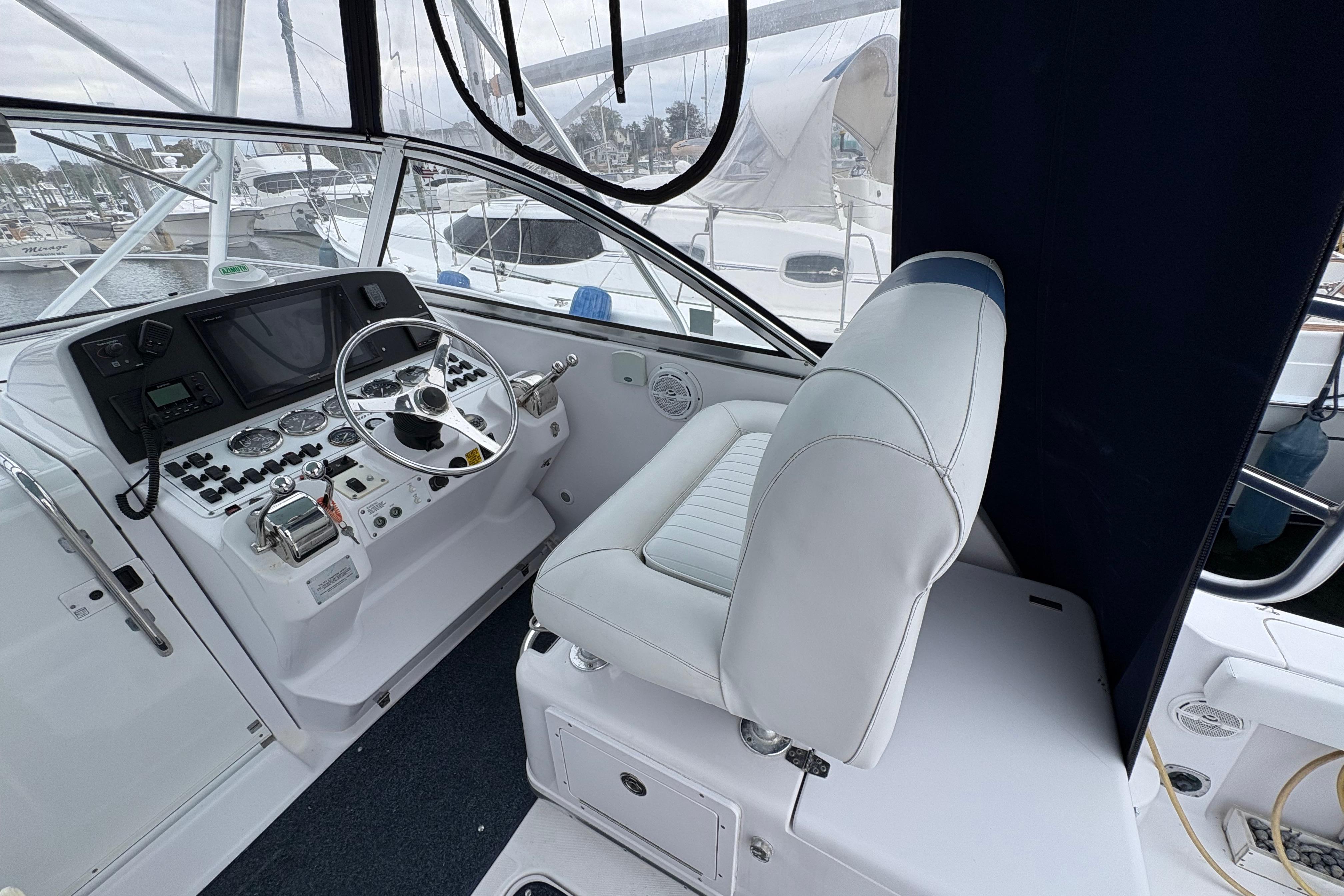 2005 Pro-Line 33 Express boat cockpit with steering wheel and control panel.