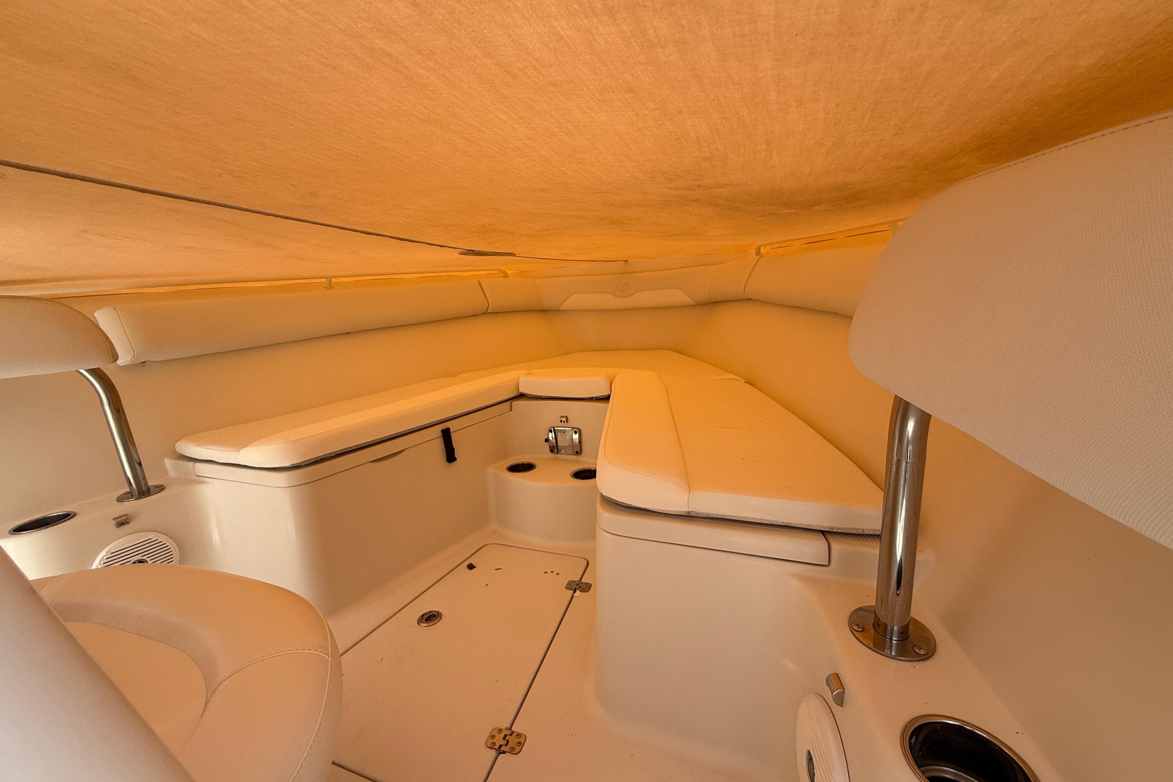 Interior cabin of 2015 Sailfish 240 CC boat with cushioned seating.