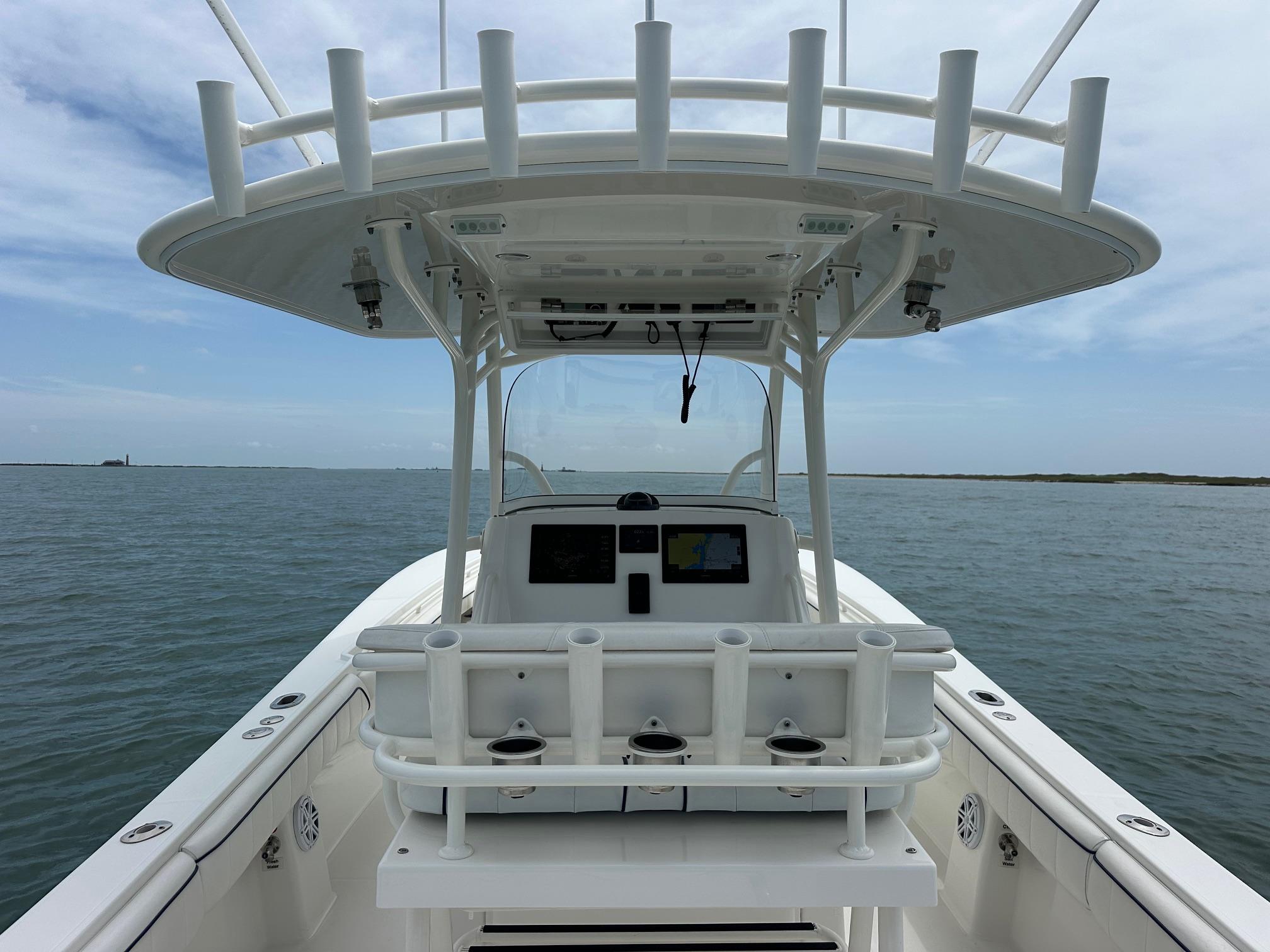 2016 Regulator center console boat on open water, featuring a spacious helm and rod holders.