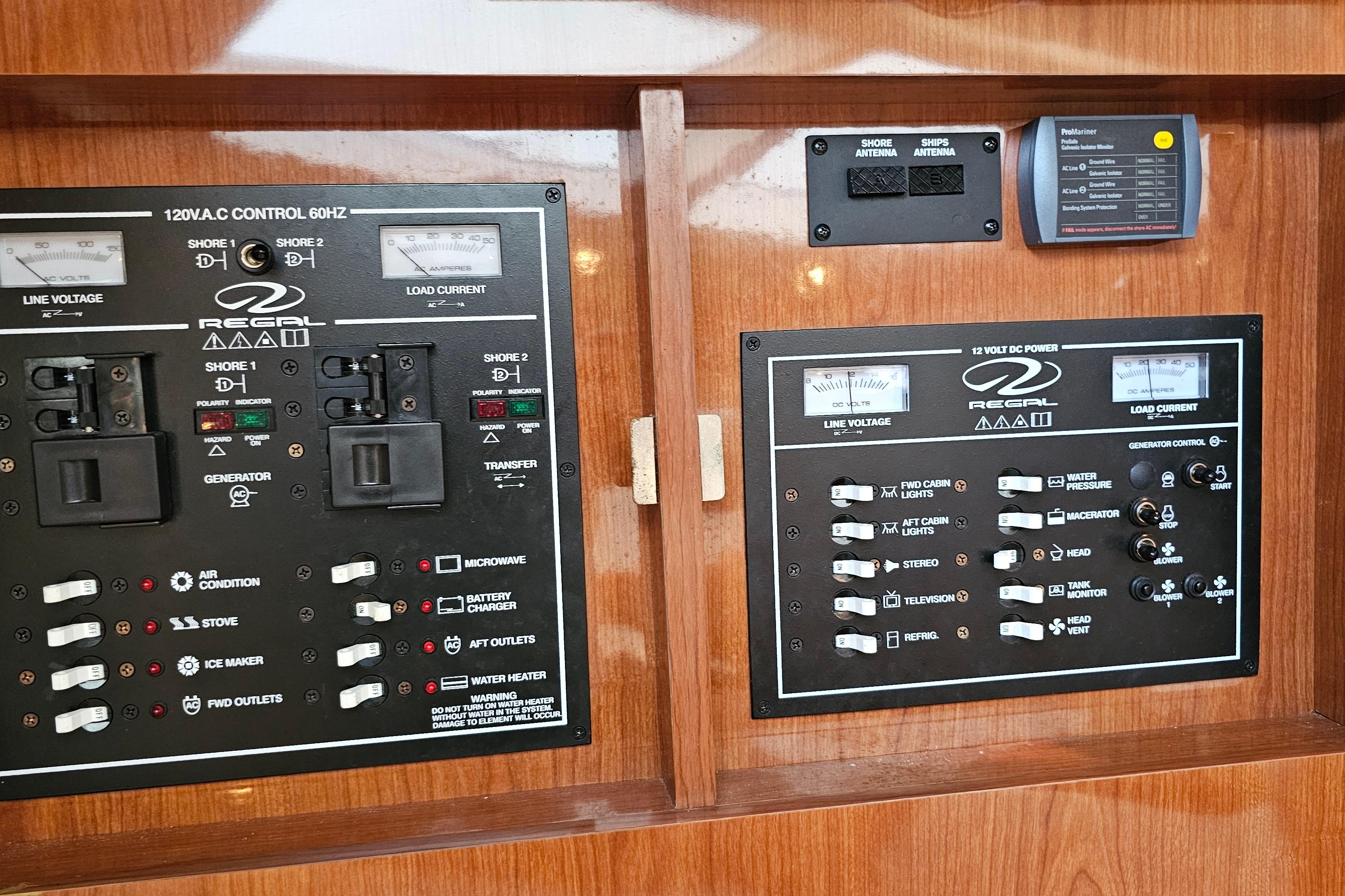 Control panel of a 2005 Regal 3060 Window Express boat, featuring various switches and gauges.