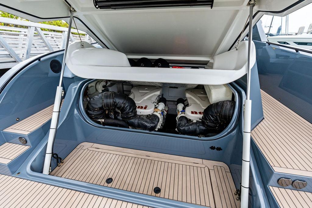 2024 Vanquish Yachts VQ55 engine compartment with open hatch, showcasing sleek design and engineering.