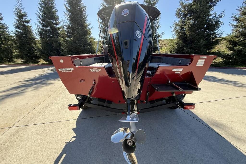 2024 Tracker Targa V-19 WT boat, rear view with outboard motor, parked outdoors.