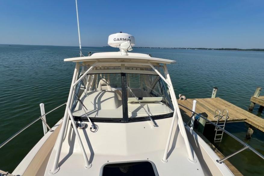 2017 Grady-White Marlin 300 boat docked on calm water with Garmin radar.