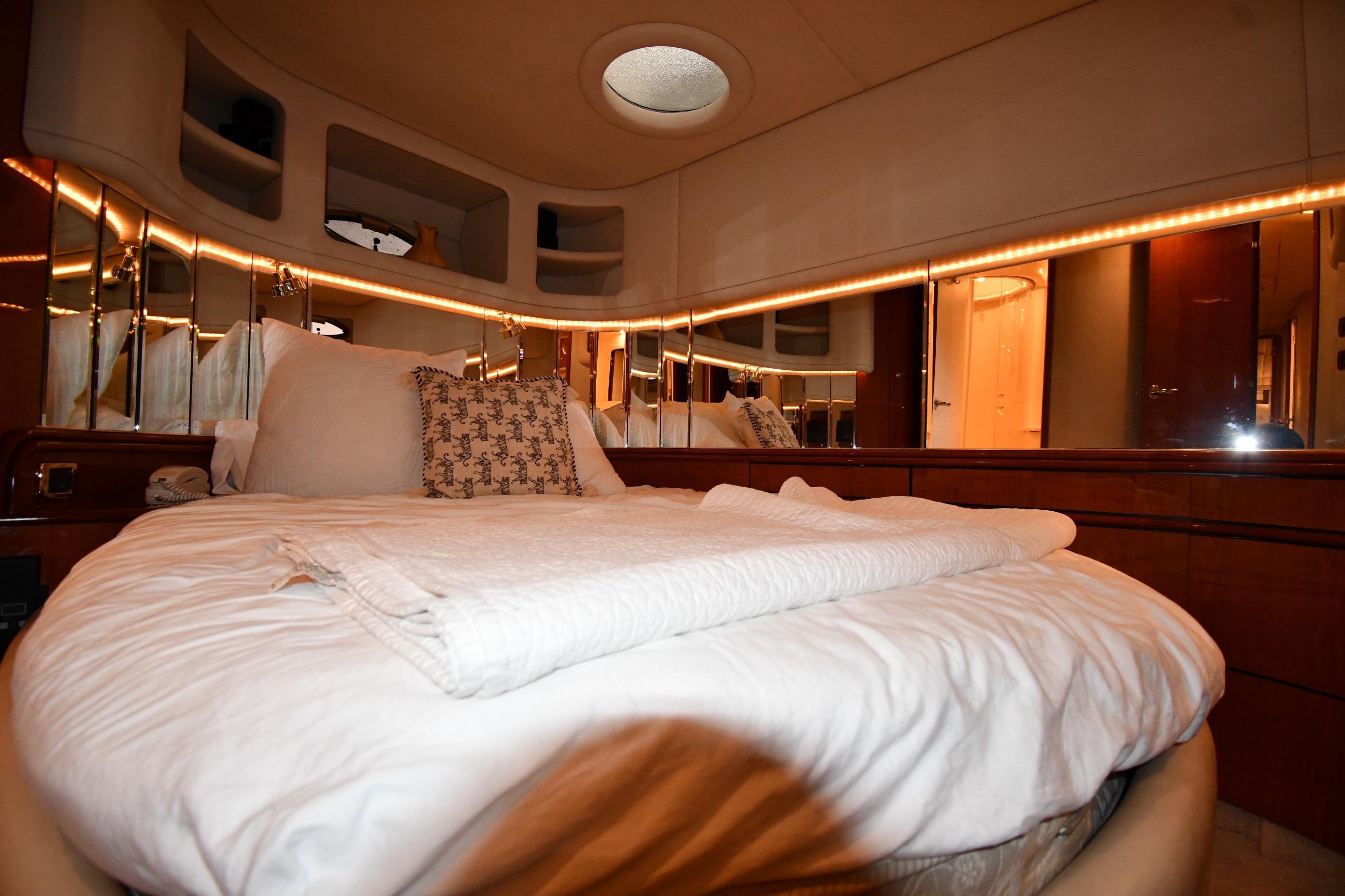 Luxurious bedroom interior of 2001 Sea Ray 540 Sundancer yacht with elegant bedding.