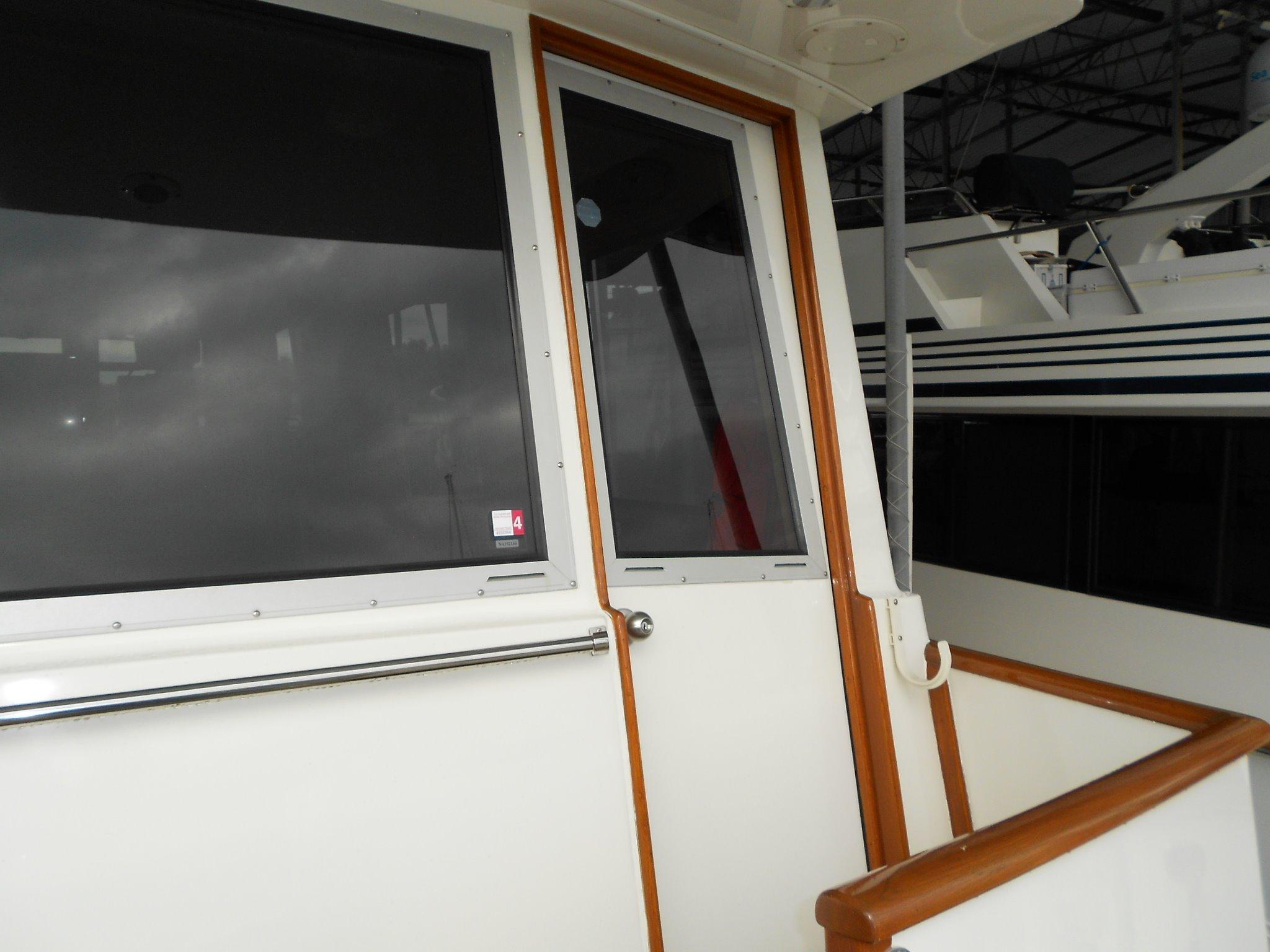 1985 Chris-Craft 500 Constellation Motor Yacht exterior with wooden trim and windows.