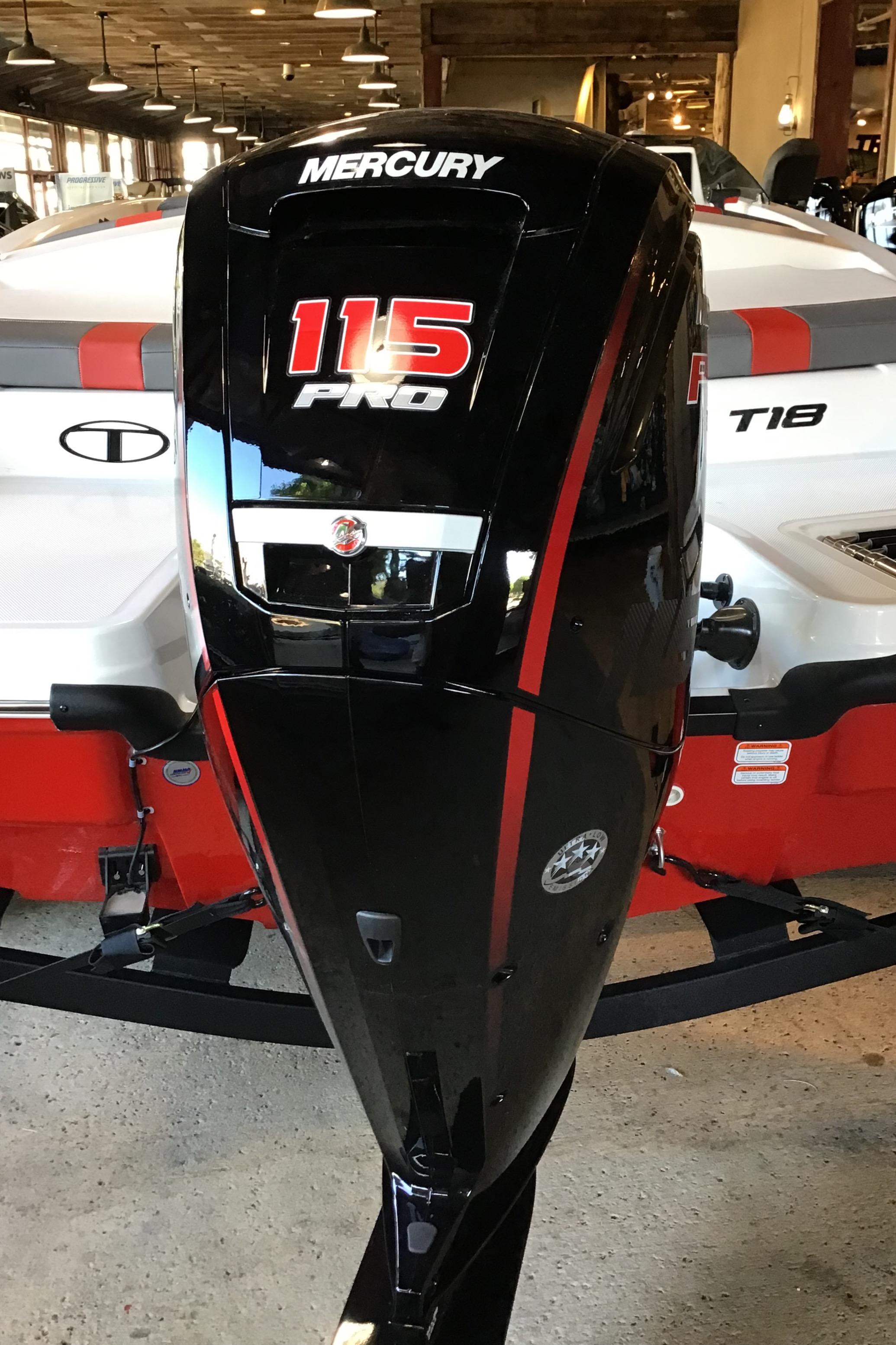 2025 Tahoe T18 boat with Mercury 115 Pro outboard motor in showroom.