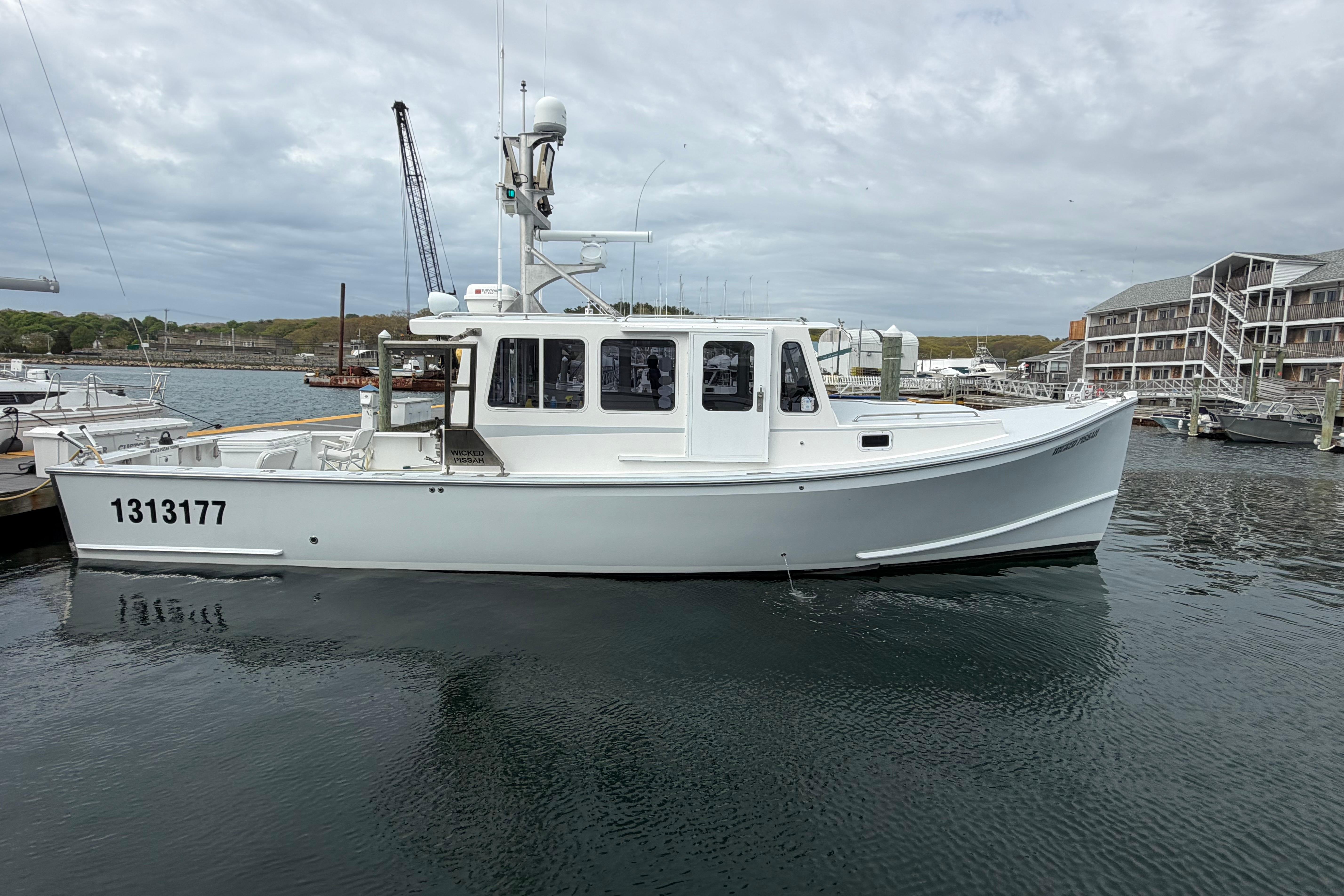 2018 H&H Marine Osmond Beal boat docked in a marina, overcast sky.