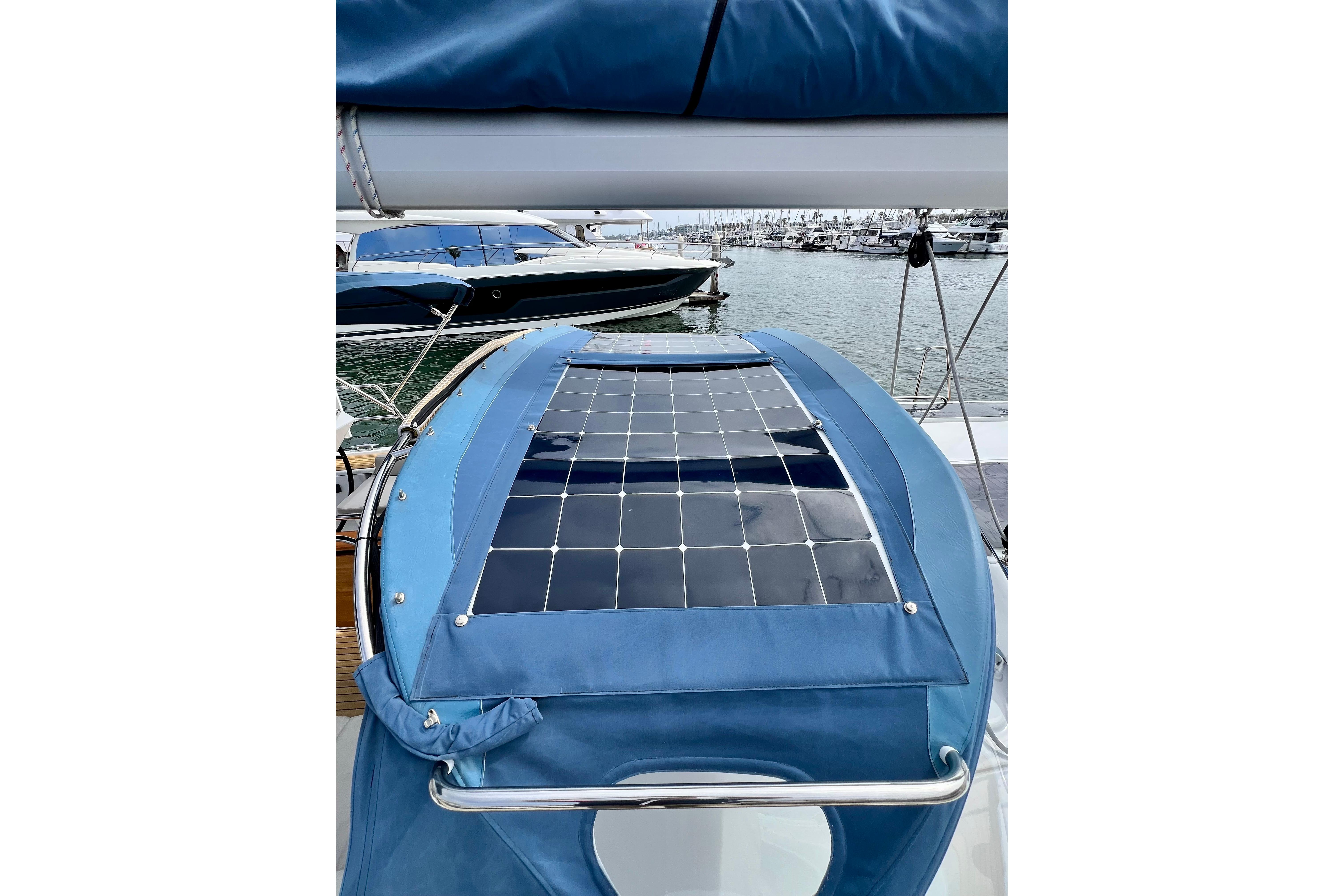 2016 Hanse 455 yacht with solar panels on blue canvas, docked at marina.