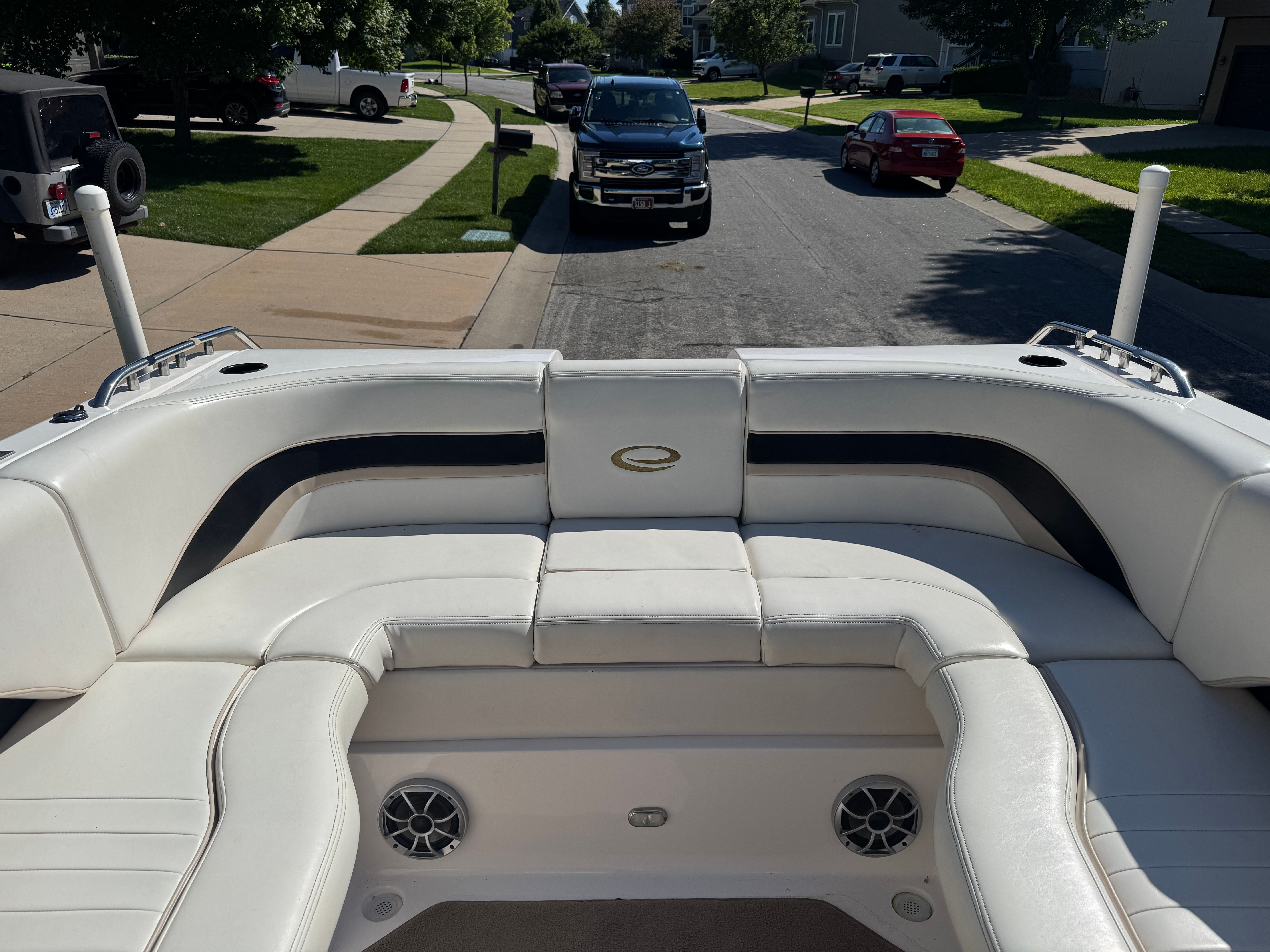 The image shows the cockpit of a 2003 Envision 2900 DLX with white upholstery and speakers.