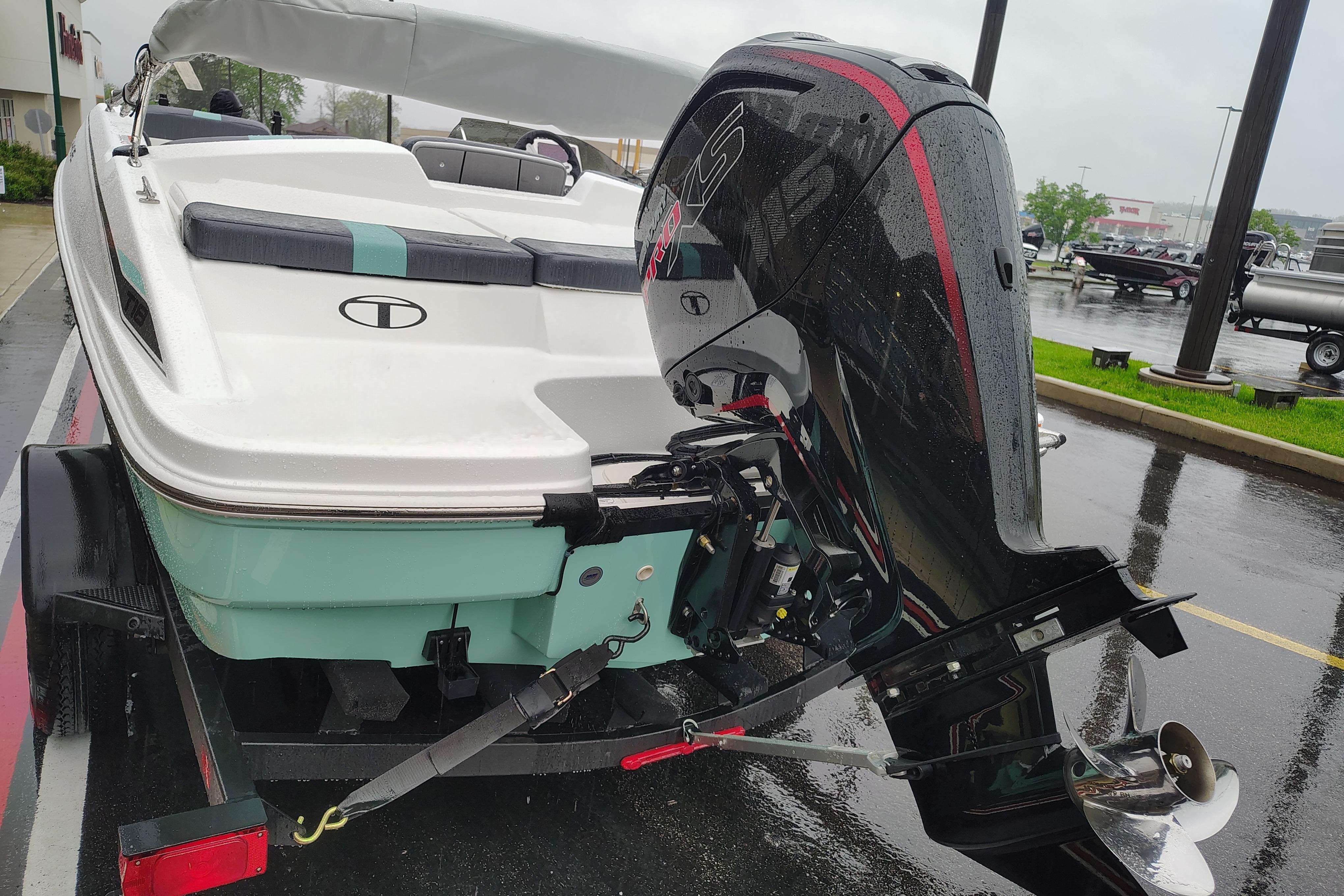 2026 Tahoe T18 boat with powerful outboard motor on a rainy day.