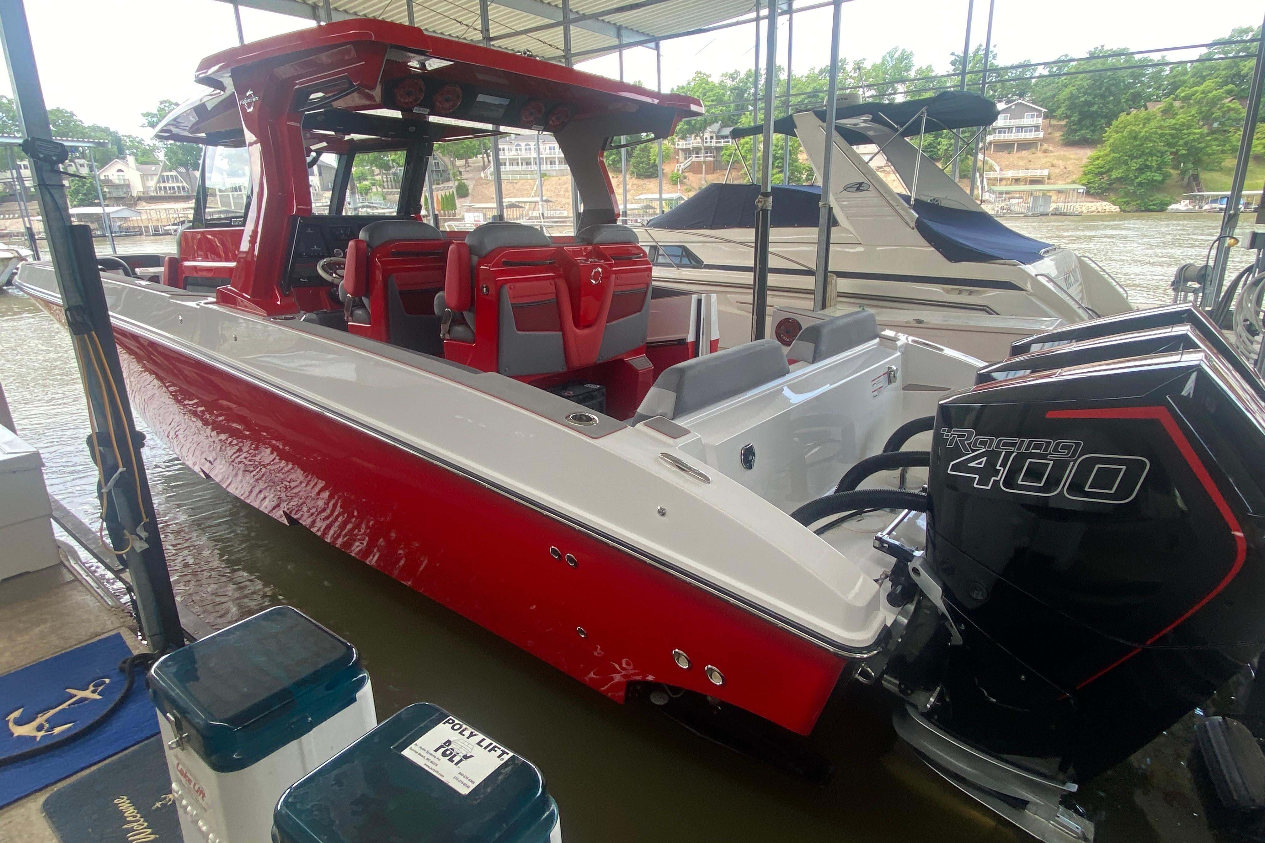 2025 Fountain 38 SCX boat with red and white design, docked with powerful Racing 400 engines.