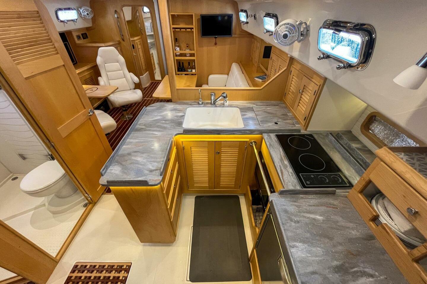 2023 Island Packet 439 yacht interior with modern kitchen, seating, and bathroom.
