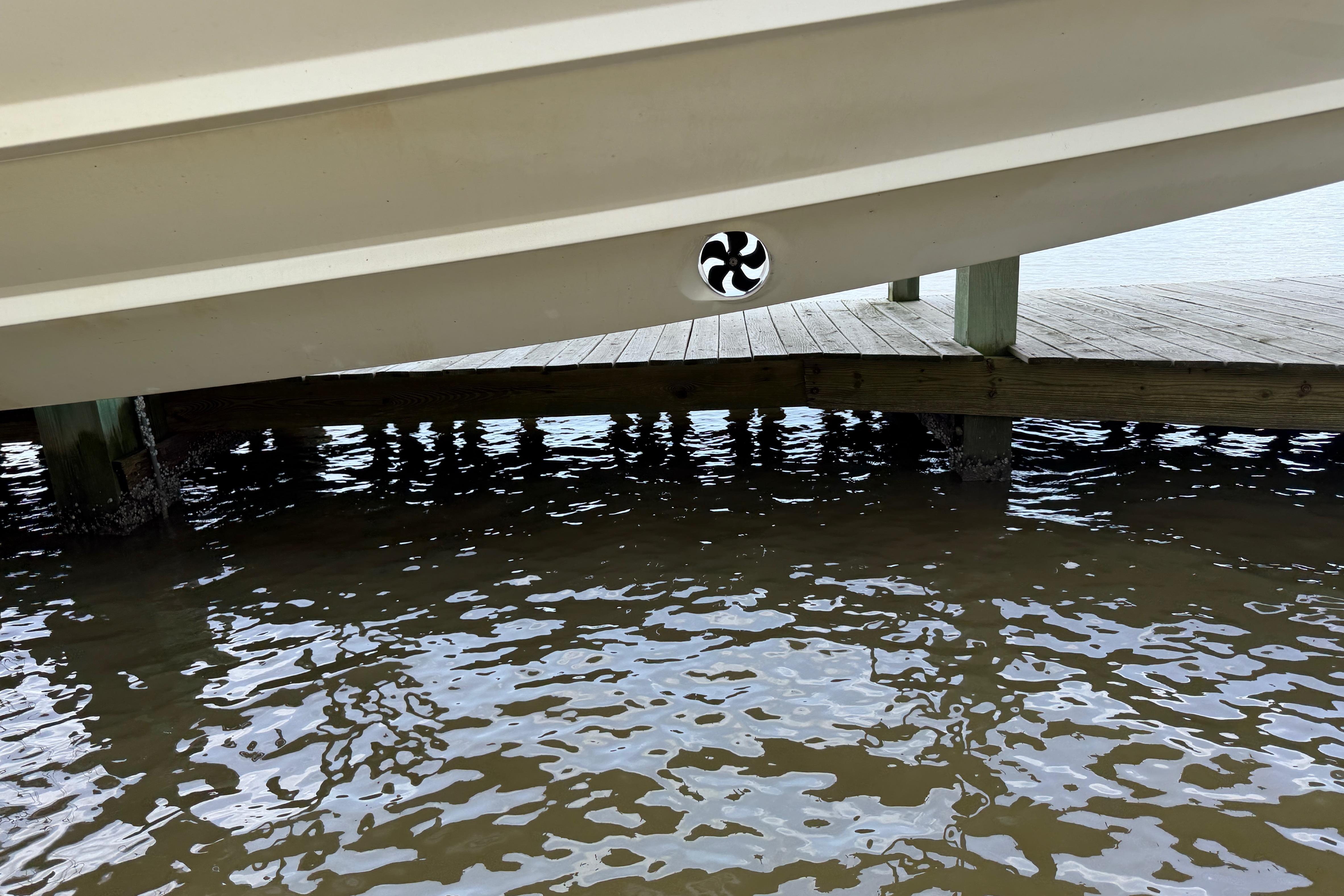 2013 Nor-Tech 477 SPX Vee Bottom boat hull near wooden dock over water.