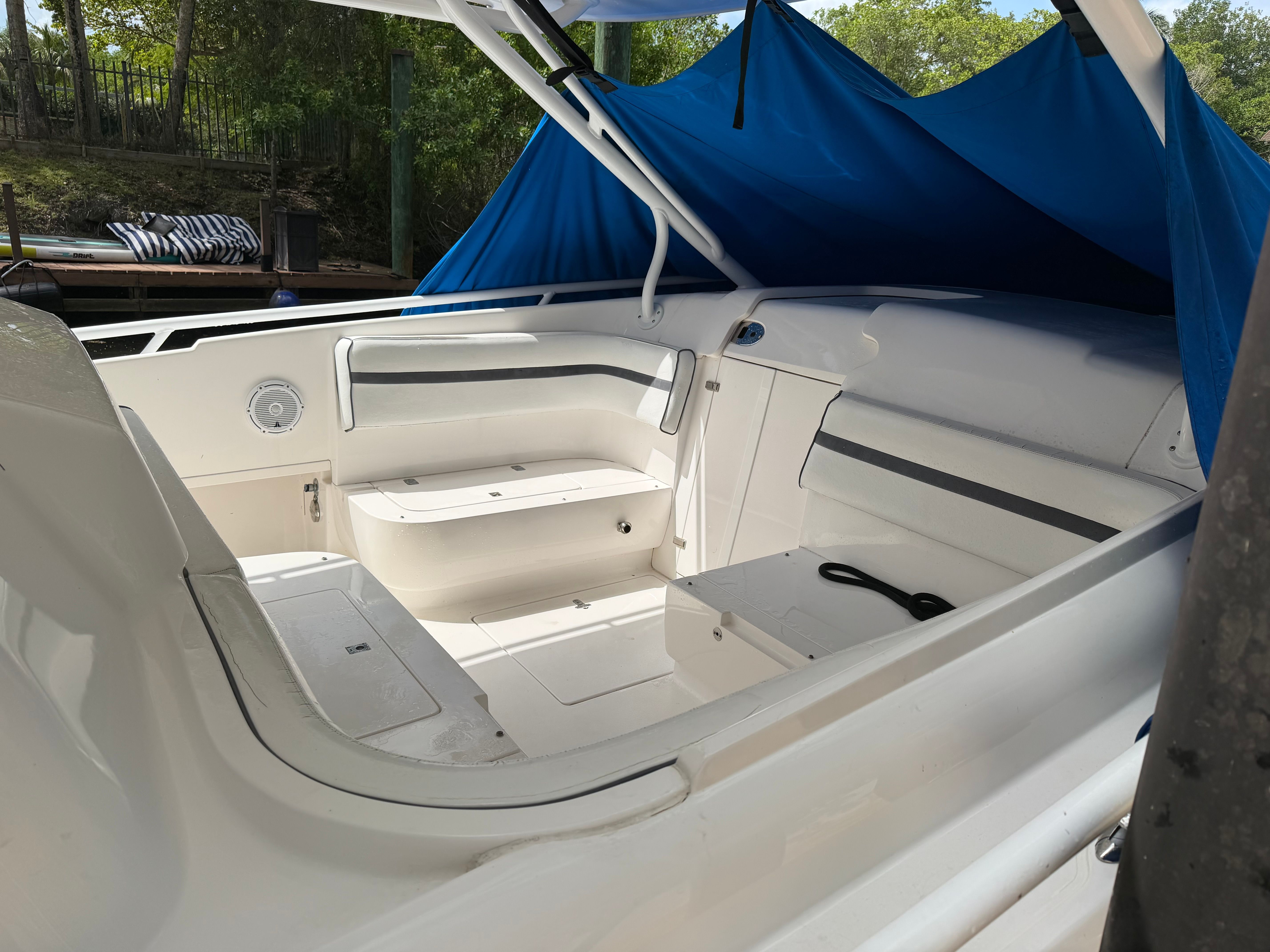 2014 Intrepid 375 Walkaround with spacious cockpit and blue cover, docked by the shore.