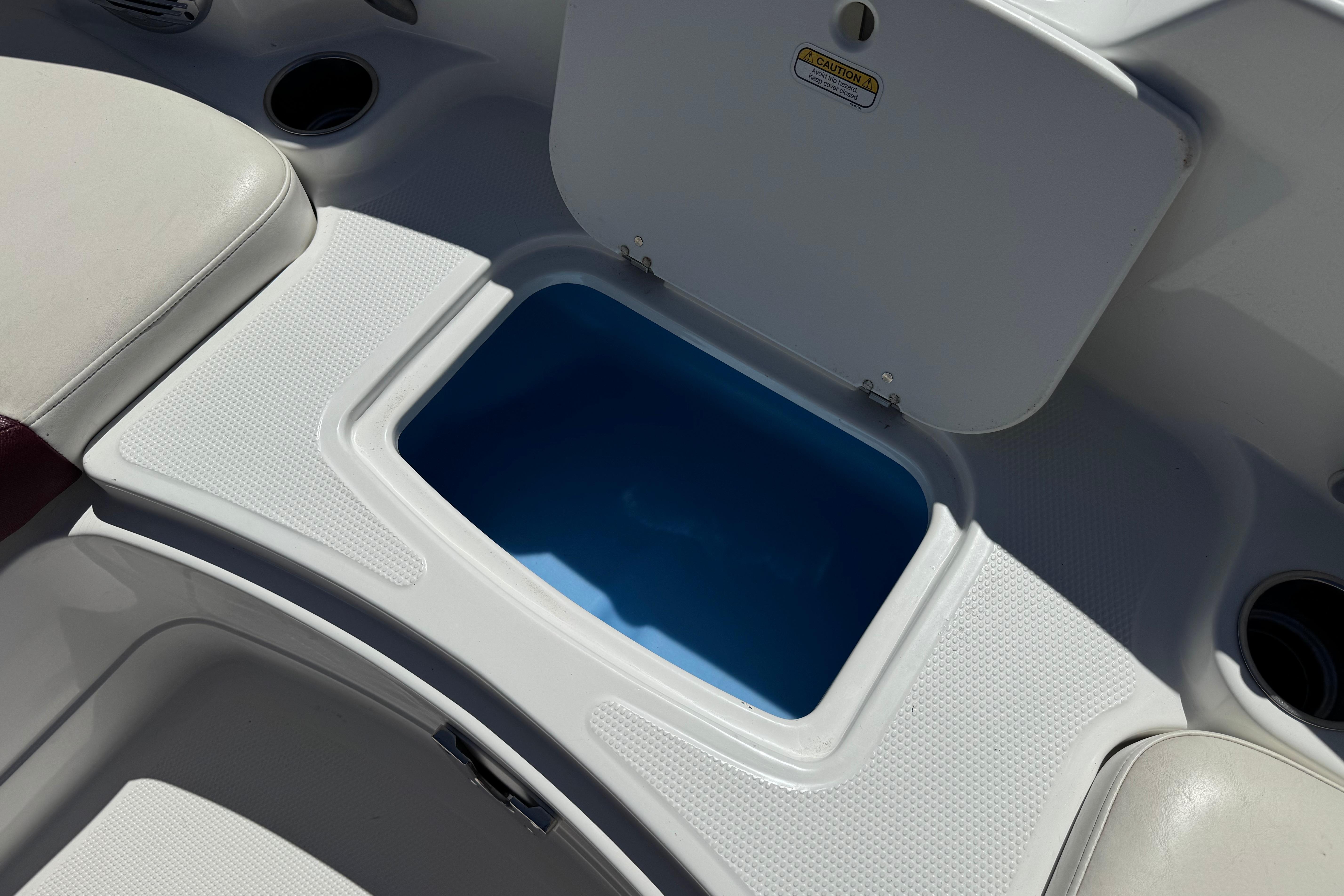 Open storage compartment on a 2017 Tahoe 2150 boat, featuring a blue interior.