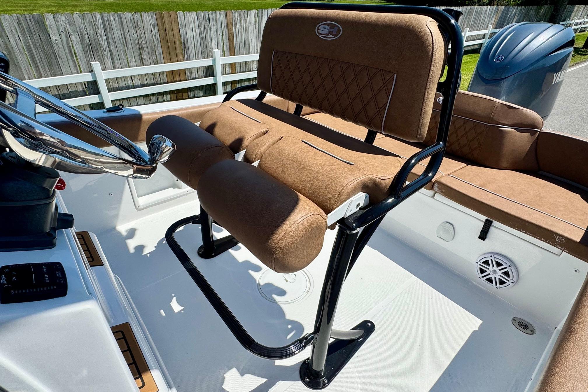 2025 Sea Hunt Ultra 219 boat interior with brown seating and steering wheel.
