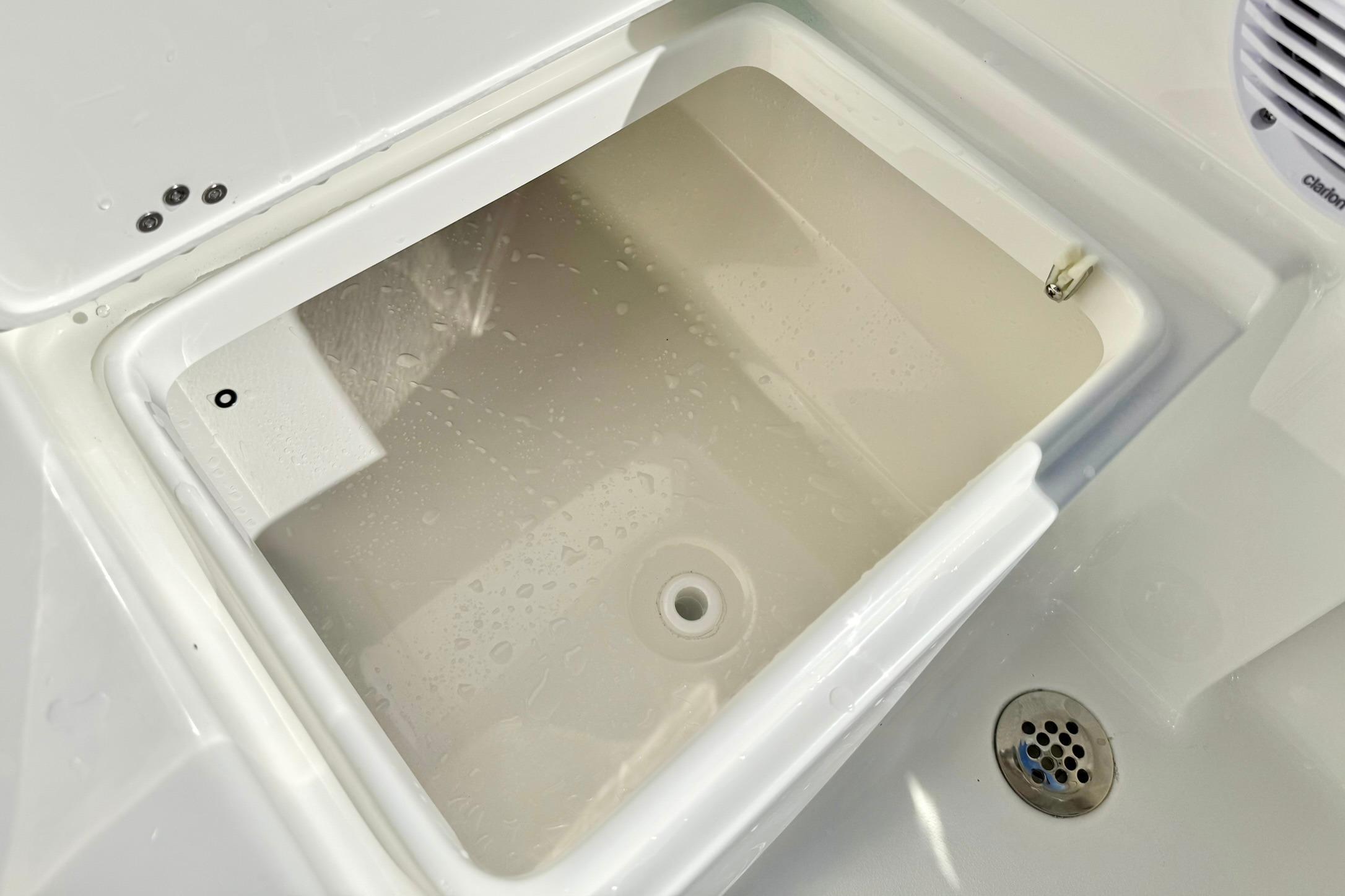 Livewell compartment on a 2026 Key West 189 FS boat, featuring a clean, white interior.