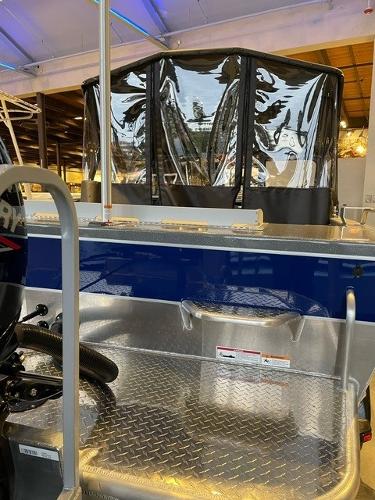 2024 Spartan 185 Astoria boat interior with diamond plate flooring and protective canopy.
